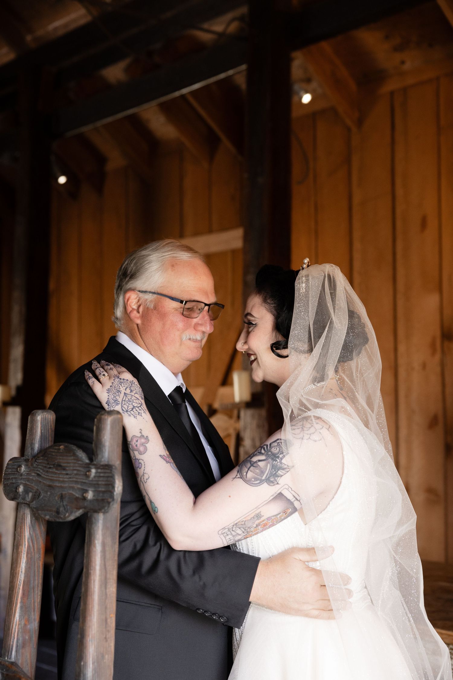 An intimate dance captured in a rustic barn setting with natural light streaming through windows.