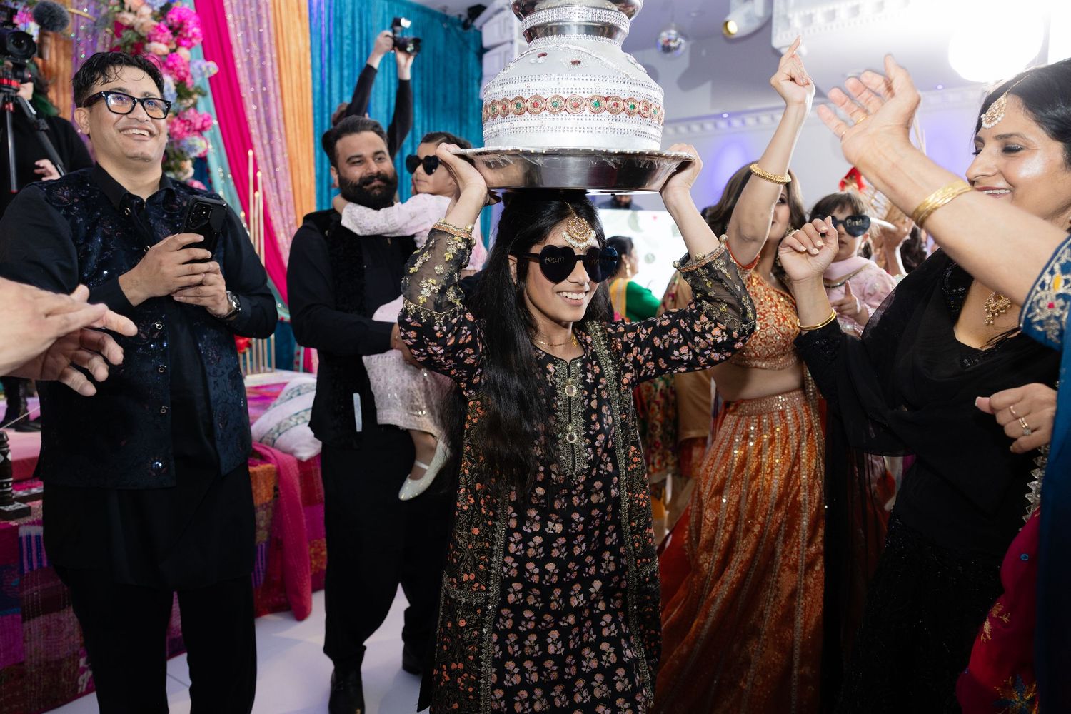 A series of celebratory moments at a party with festive decorations and people dancing and socializing.