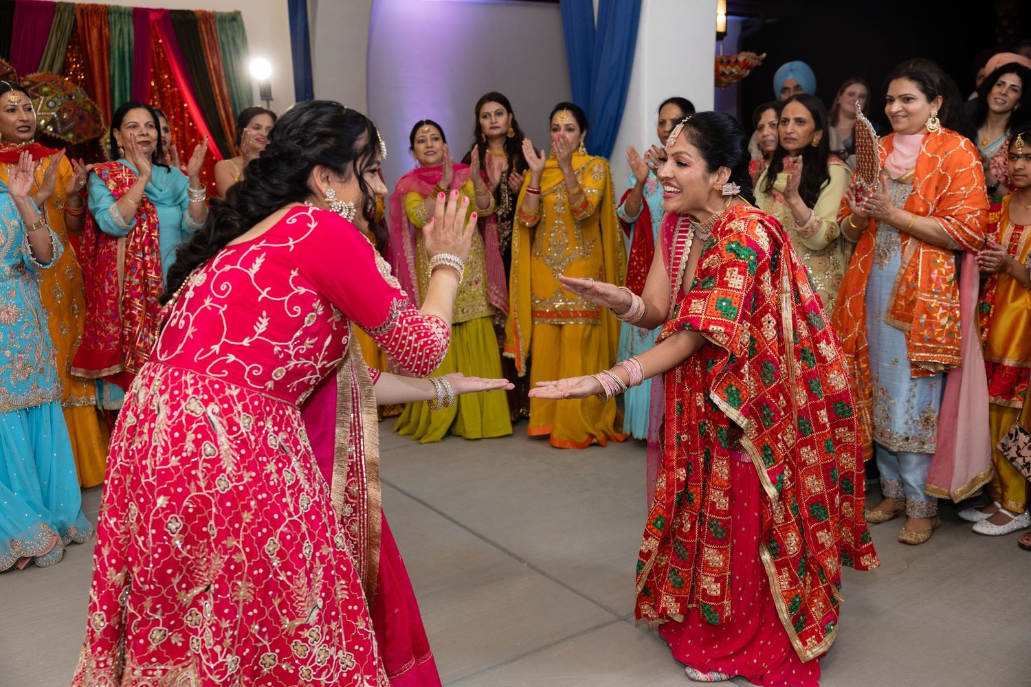 Colorful celebration at an Indian wedding with guests in traditional attire dancing and enjoying festivities.