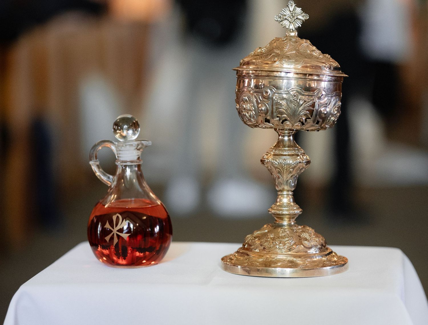 Ornate golden ceremonial vessels and containers displayed on a table.