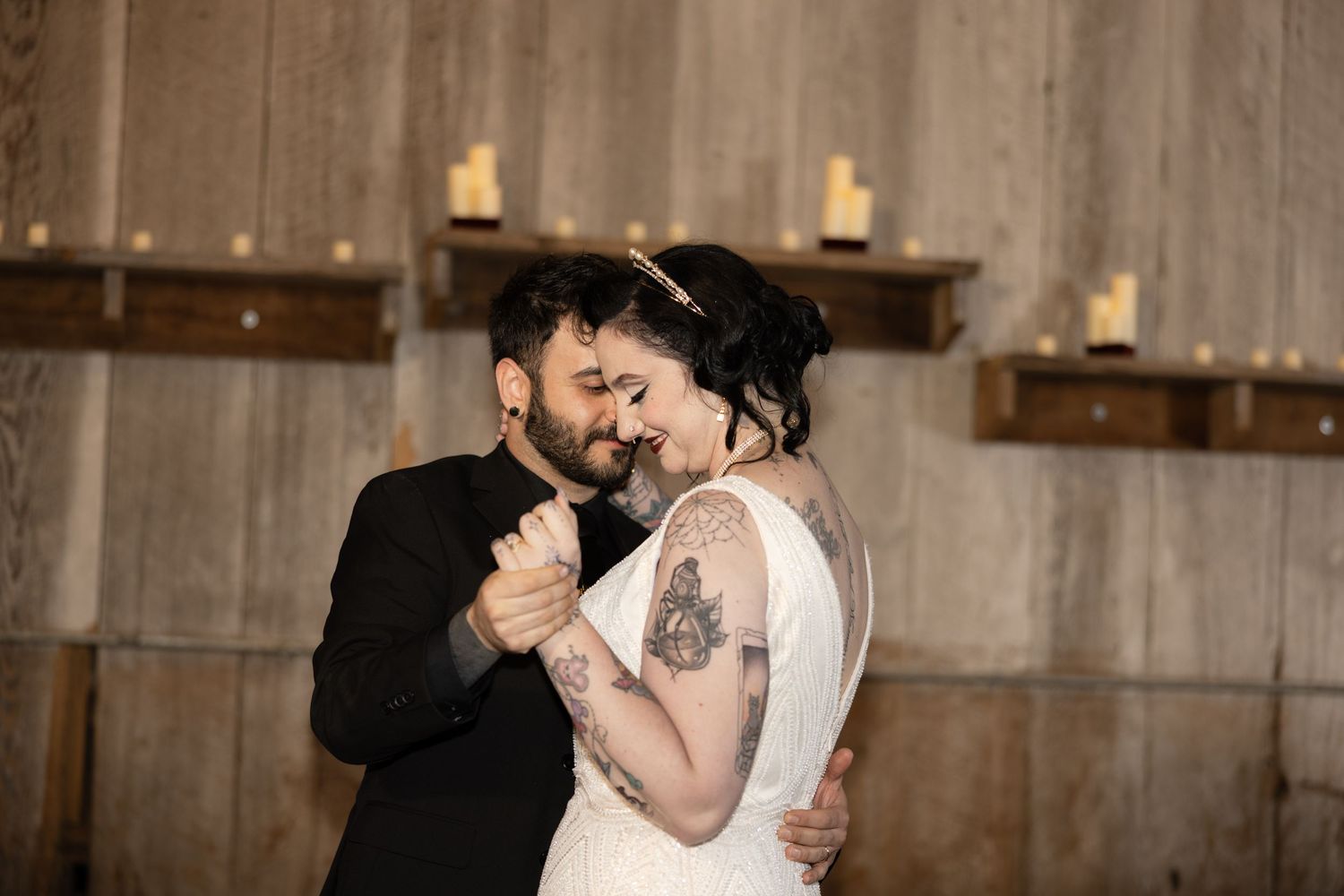 Intimate dance sequence captured in a rustic wooden barn setting with ambient lighting.