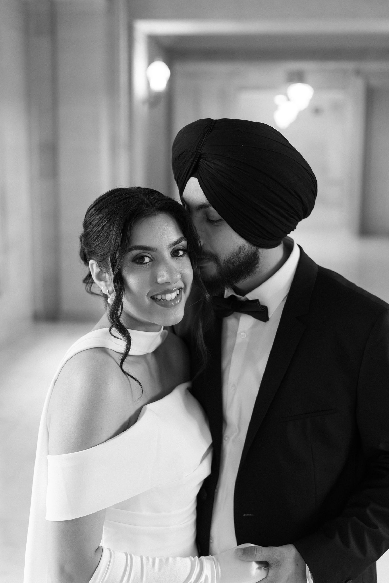 Black and white wedding portraits in an elegant hallway setting.