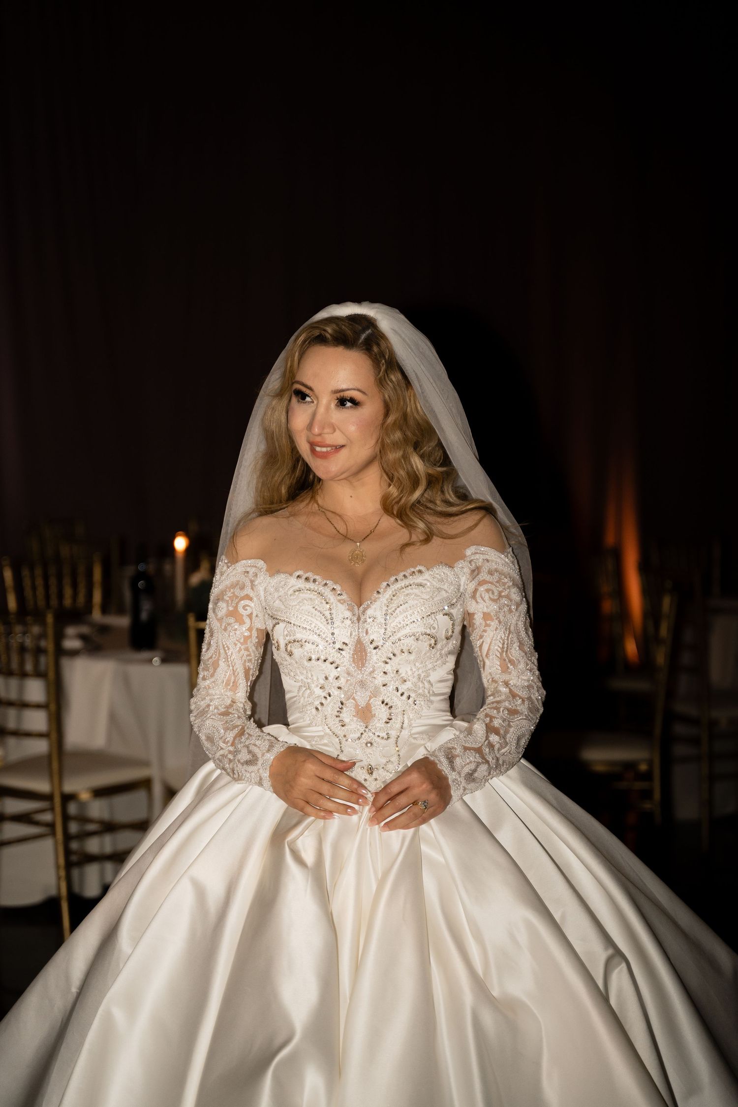 A wedding dress with lace sleeves and full satin skirt shown in a series of detailed shots.