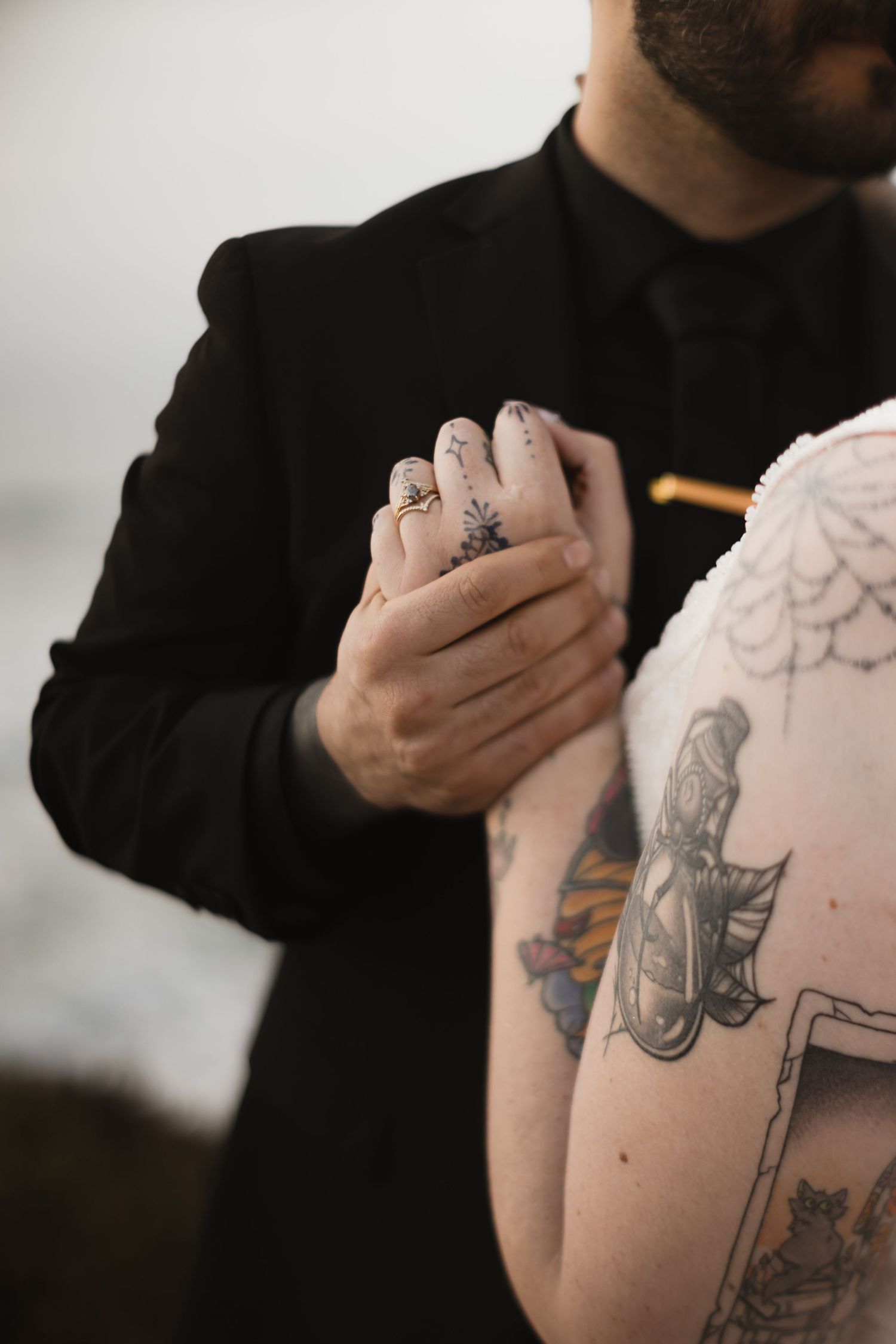 Detailed view of artistic tattoos during intimate moment in black and white.