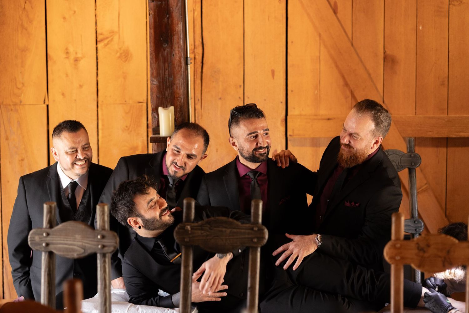 Group gathered in rustic barn interior with wooden walls.