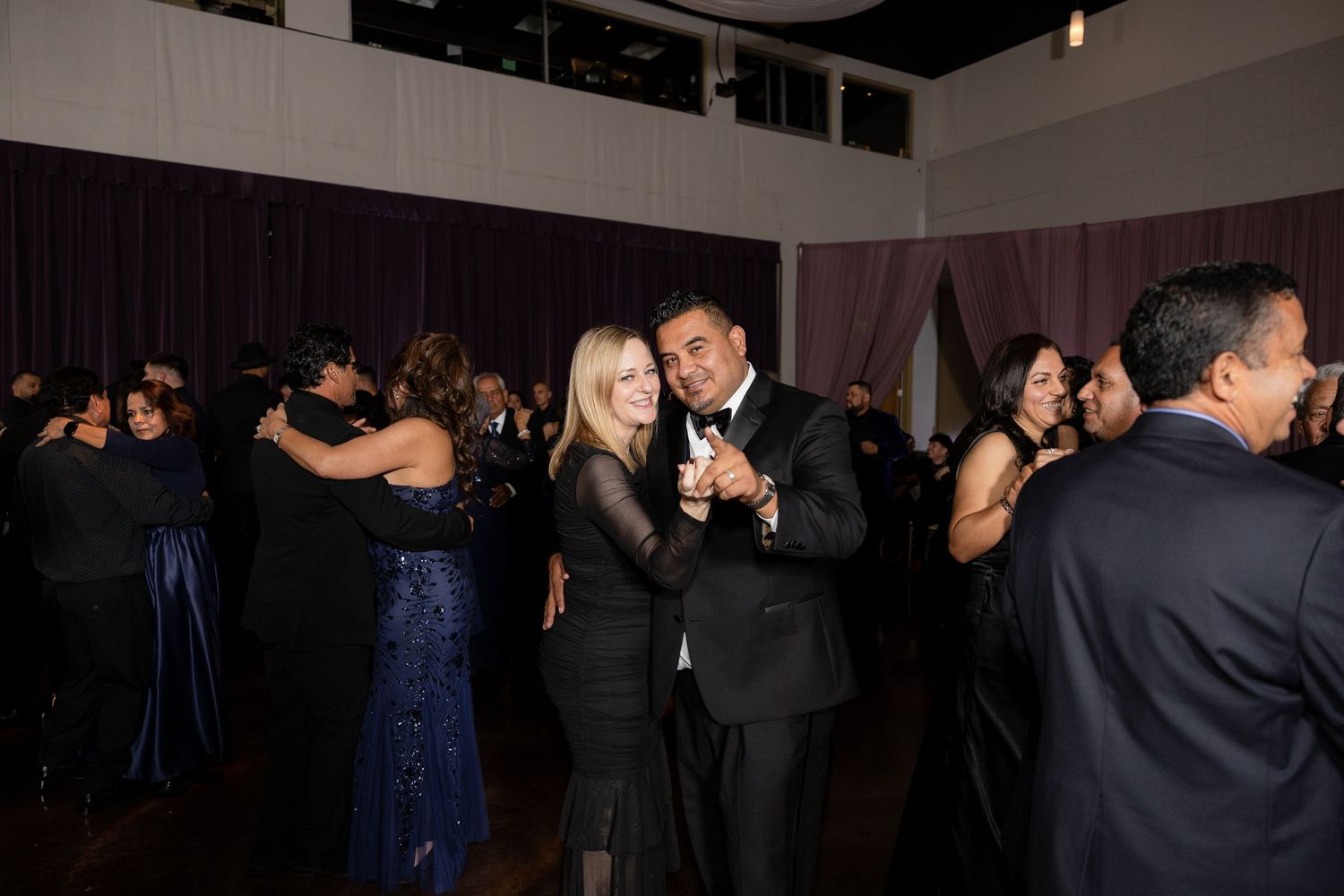 Wedding reception dance floor filled with guests enjoying the celebration.