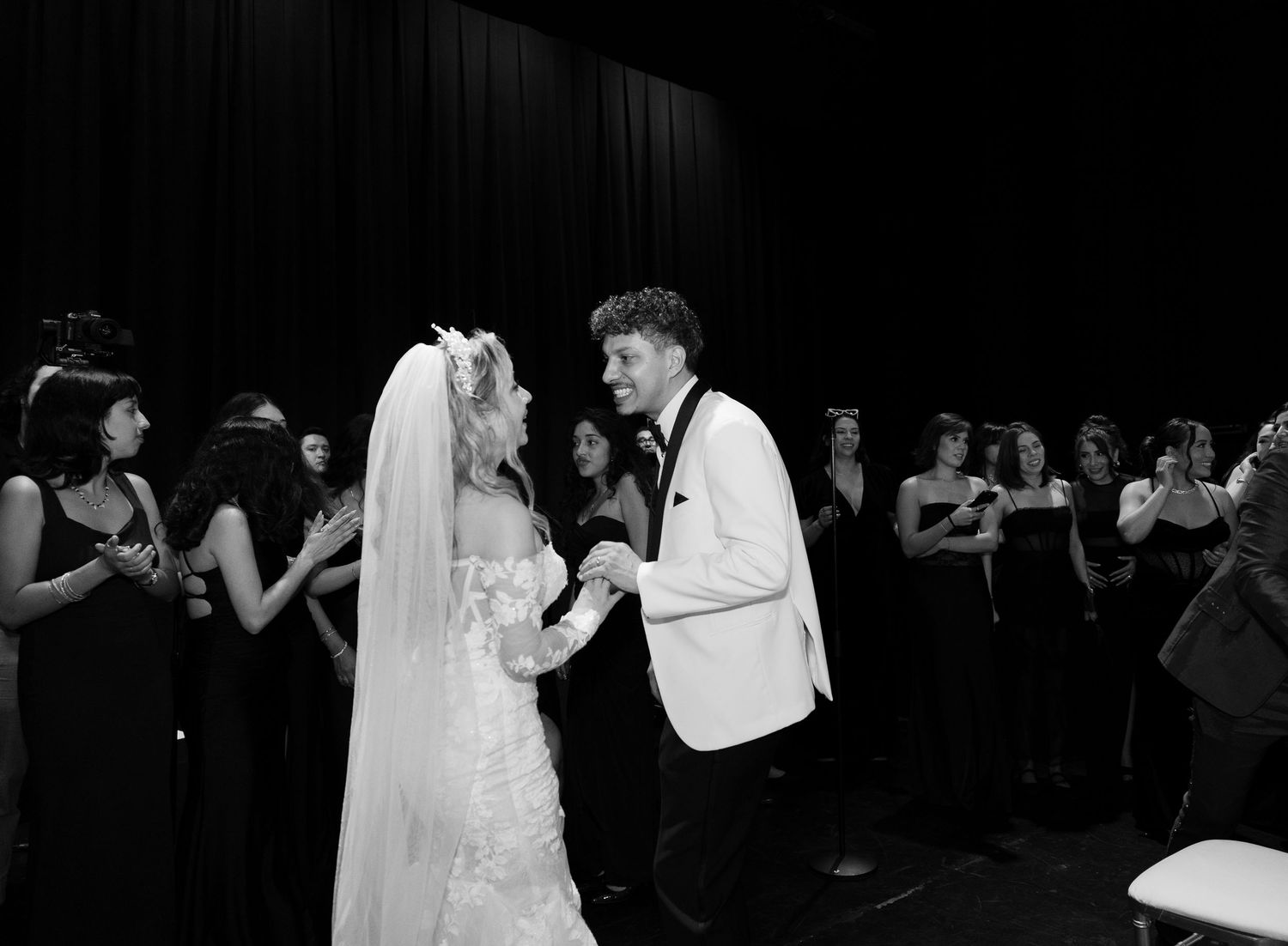 Dark atmospheric shots of wedding reception with dancing guests in formal attire.
