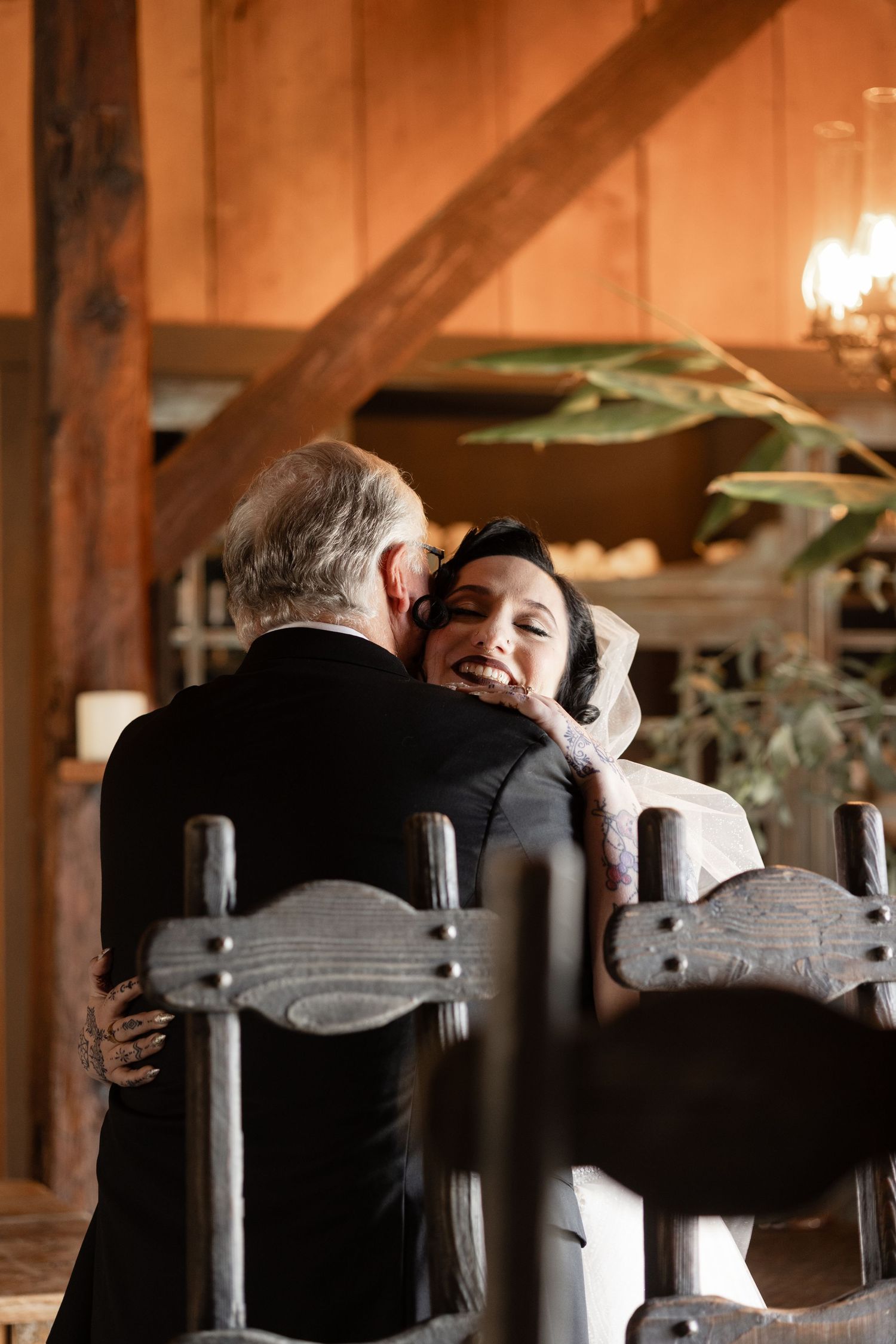 Warm-toned photograph capturing an emotional moment in a rustic wooden interior.