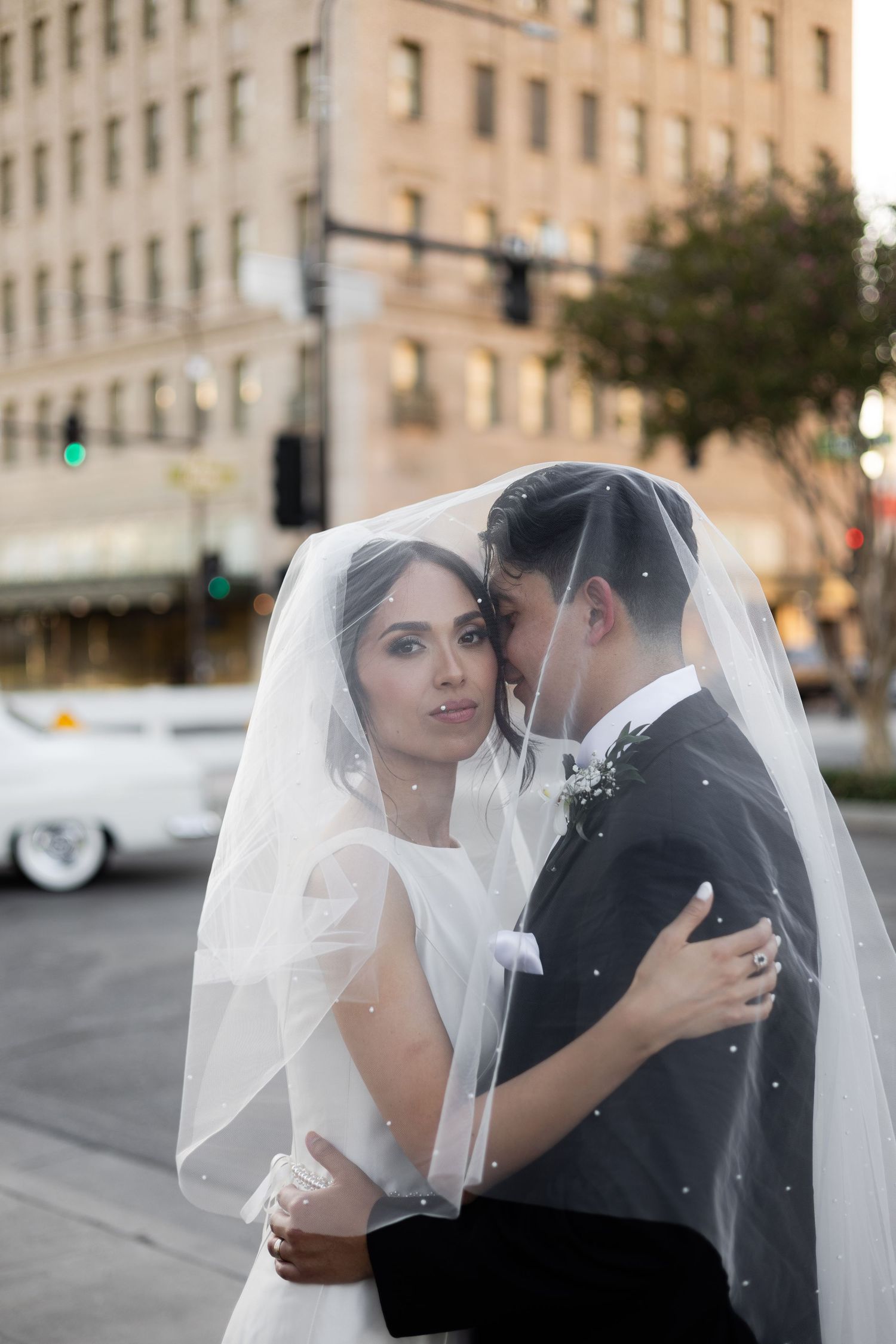 Intimate wedding portraits captured against an urban backdrop with classic architecture.
