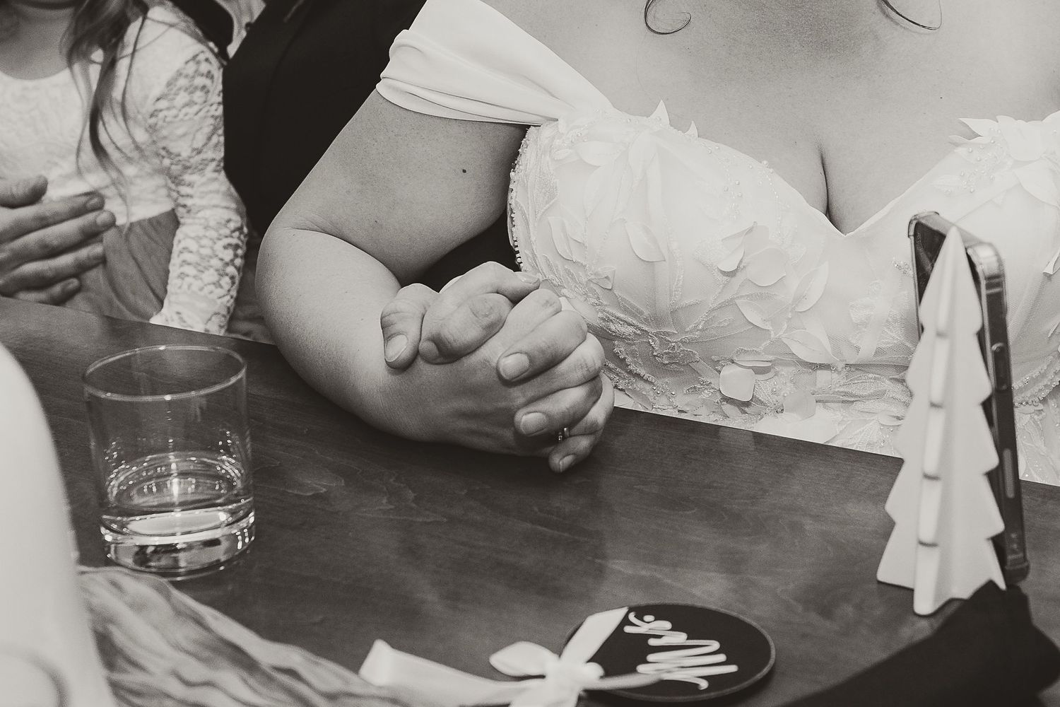 Black and white wedding detail shots showing hands and rings.