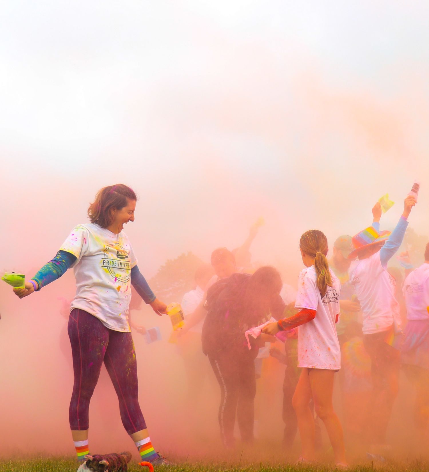 People throwing colorful powder during a festival celebration.