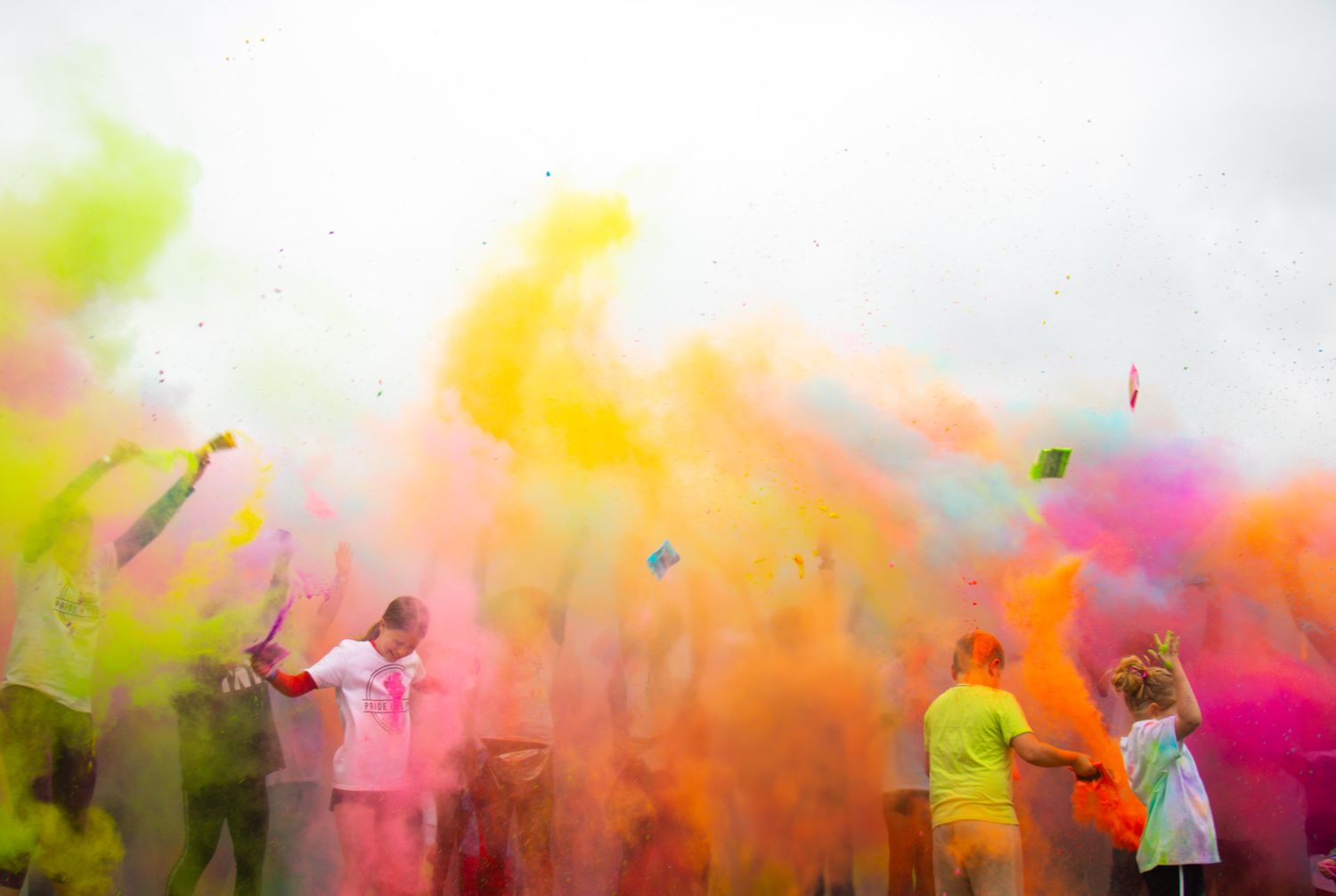 Colorful powder explosion creating vibrant clouds in the air.
