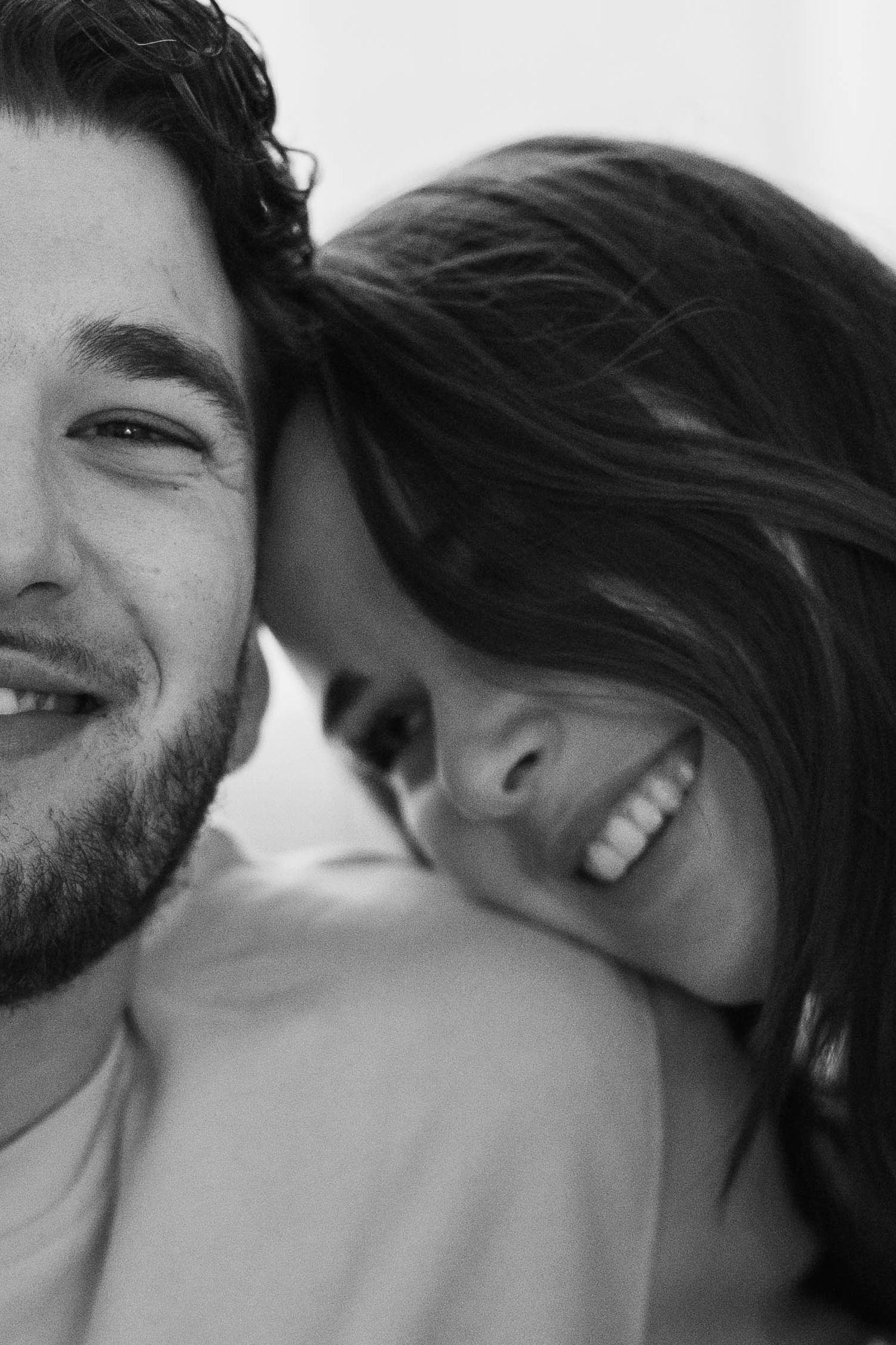 Black and white sequence capturing intimate laughing moments between two people in close proximity.