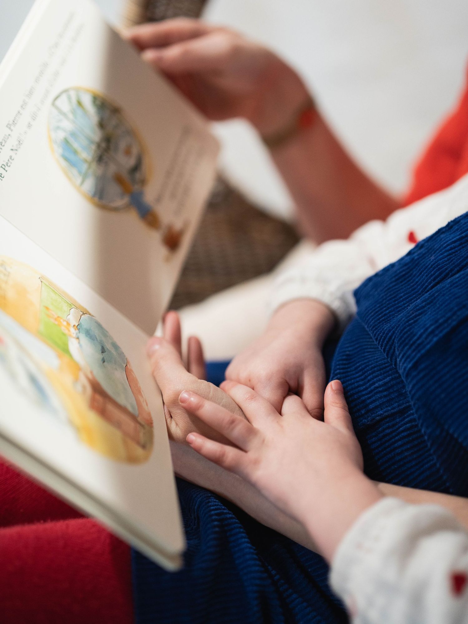 Close-up shots of hands turning pages in a book during story time.