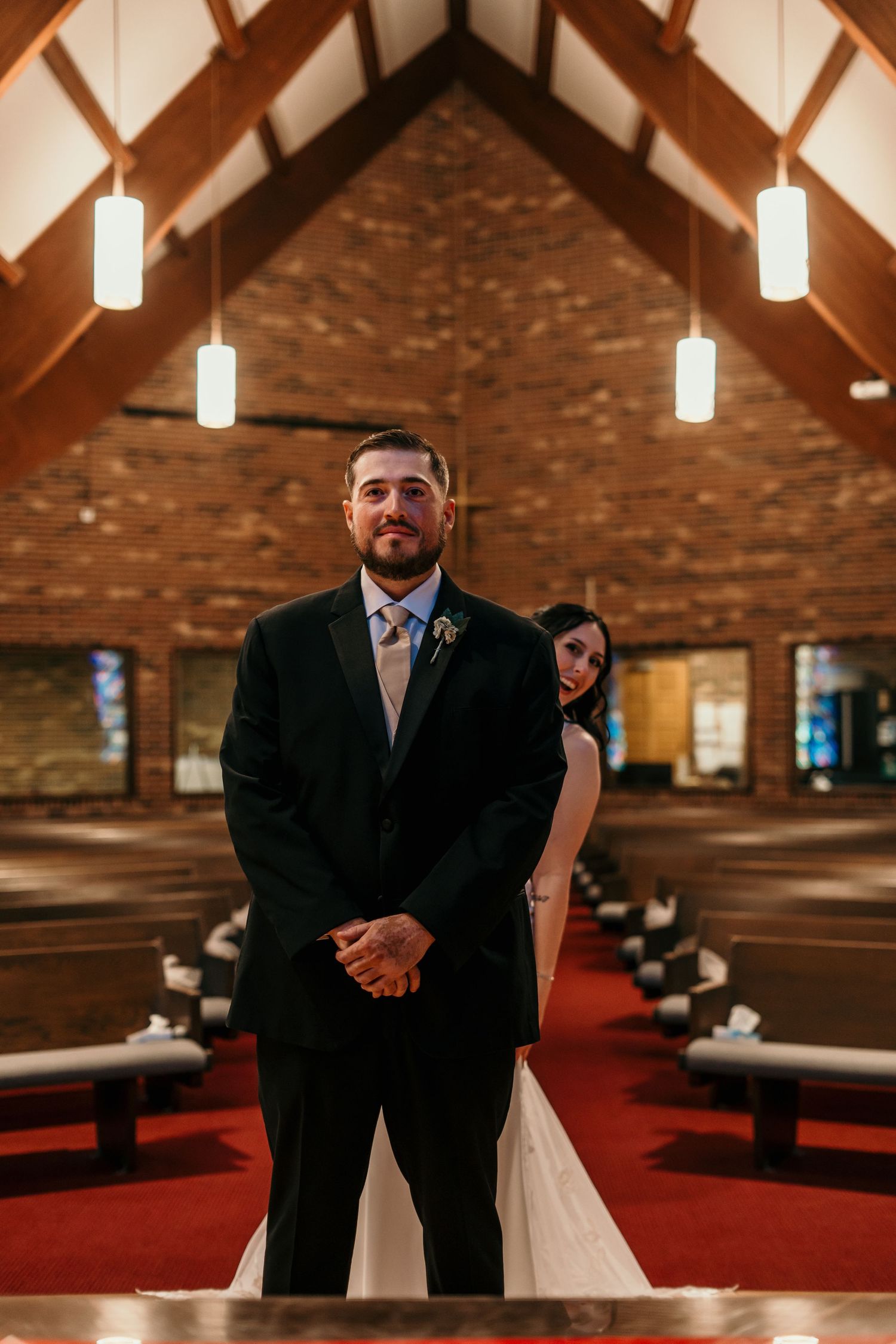 Bride and groom prepare for their first look at the altar.