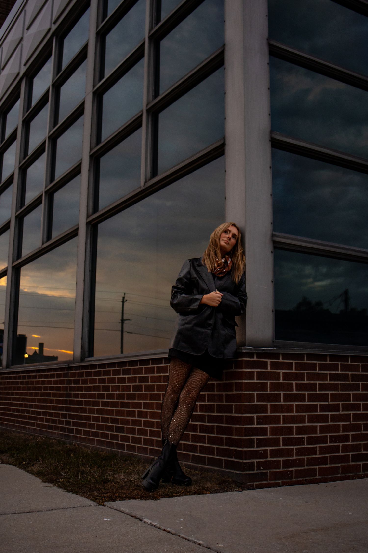 Woman posing against a building