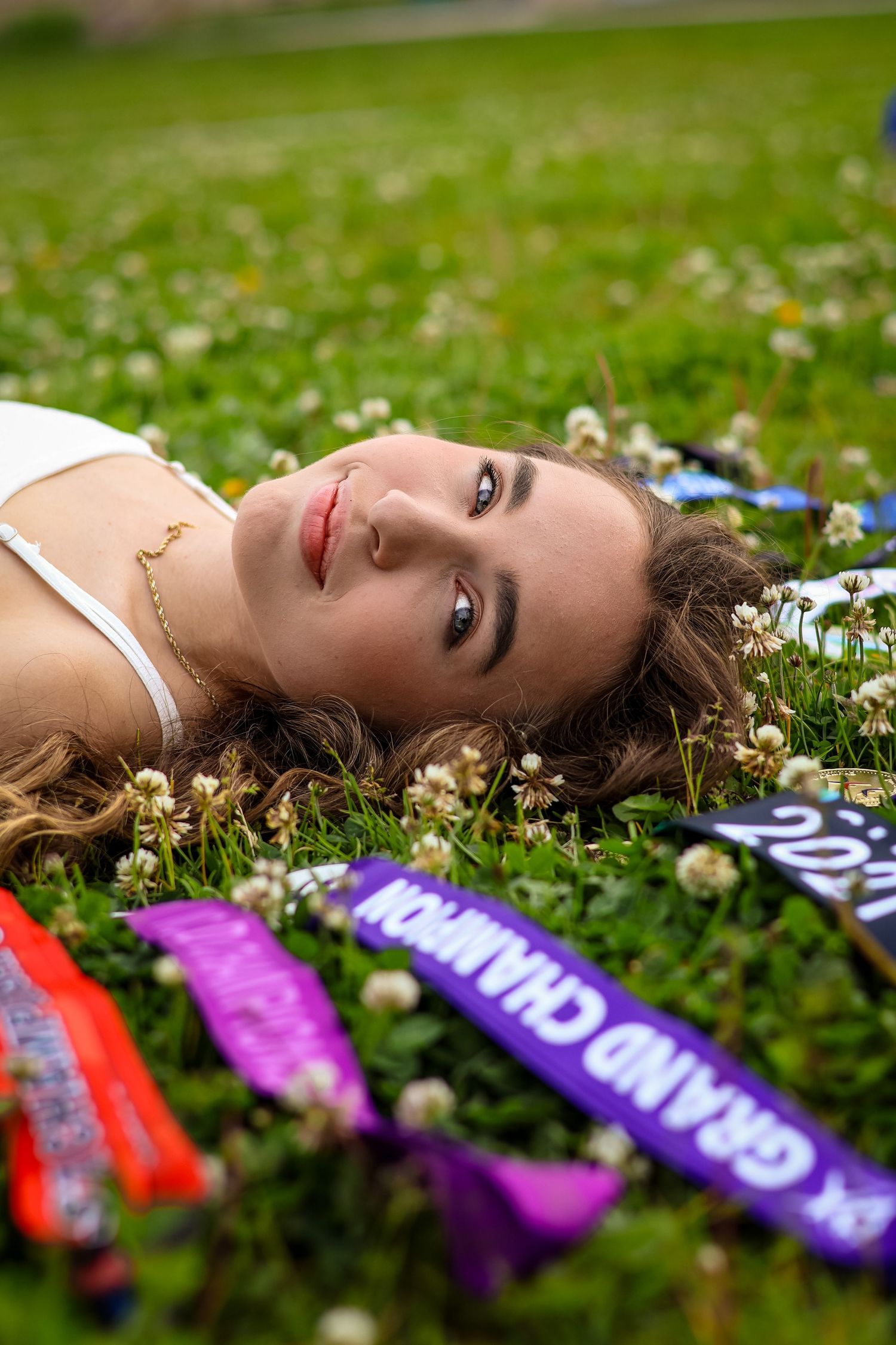 Girl in the grass with awards