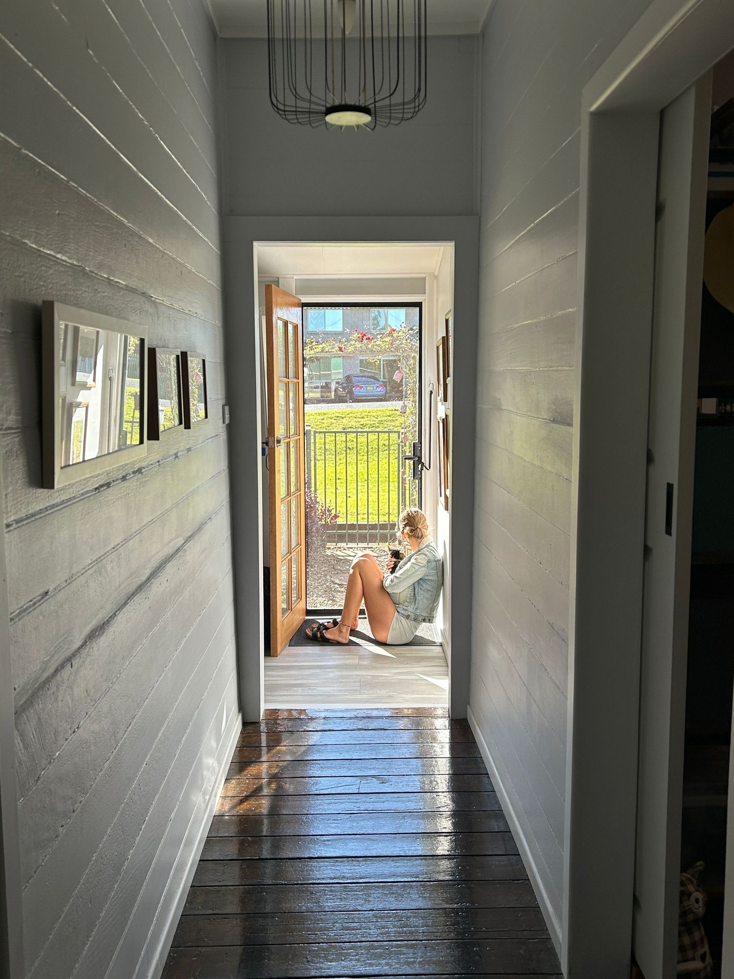 A series of minimalist hallway shots showing a bright interior corridor with white walls and dark flooring.