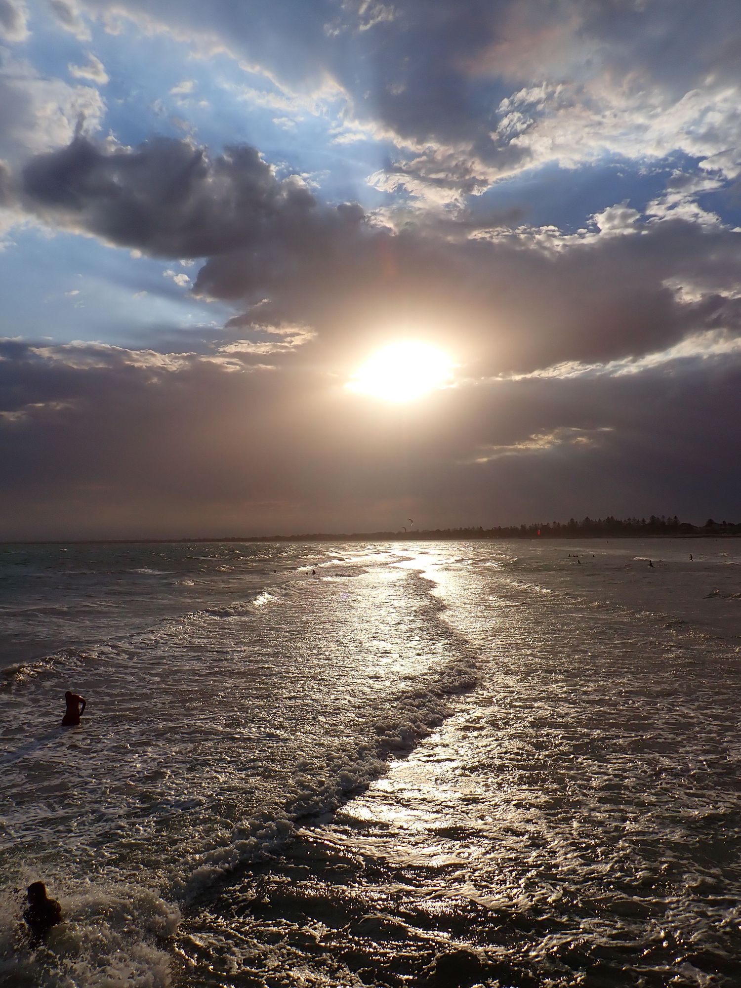 Dramatic seascape with sunlight breaking through storm clouds over choppy waters. Altona Pier.