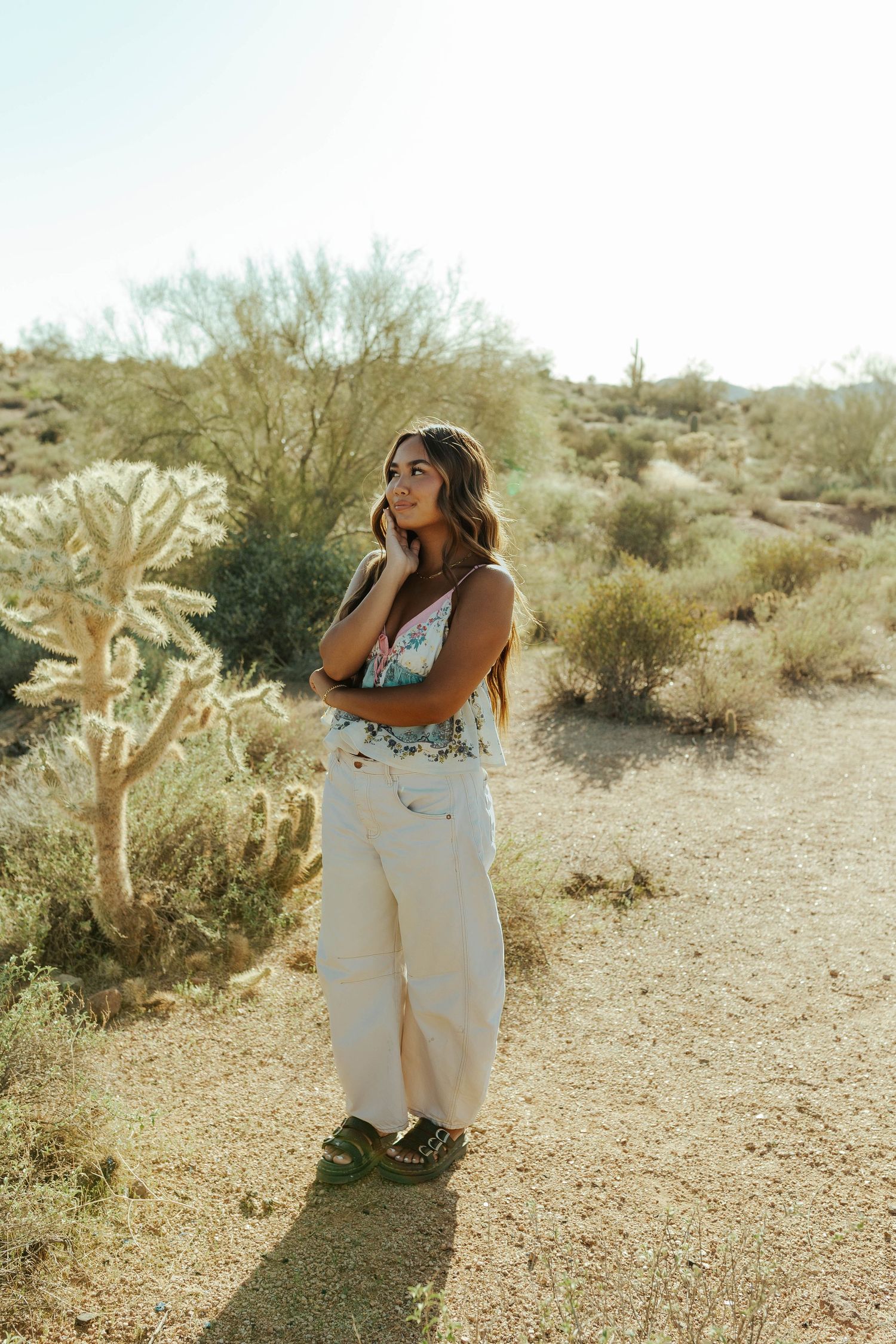A desert fashion shoot featuring white attire and natural desert landscape with saguaro cacti.