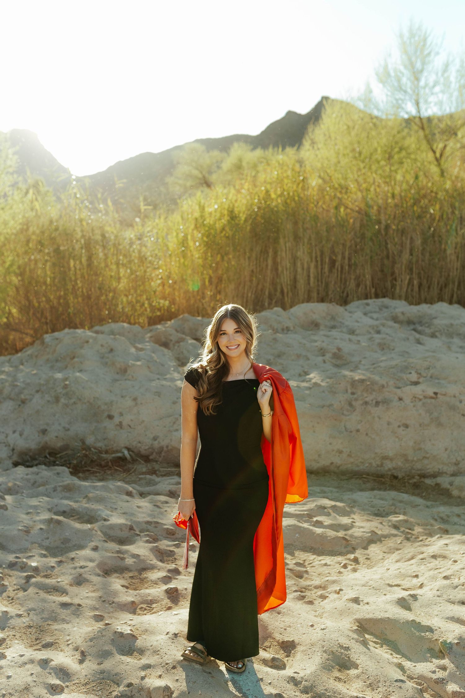 Arizona Senior and Grad photographer capturing cap and gown photos on a gorgeous sandy background