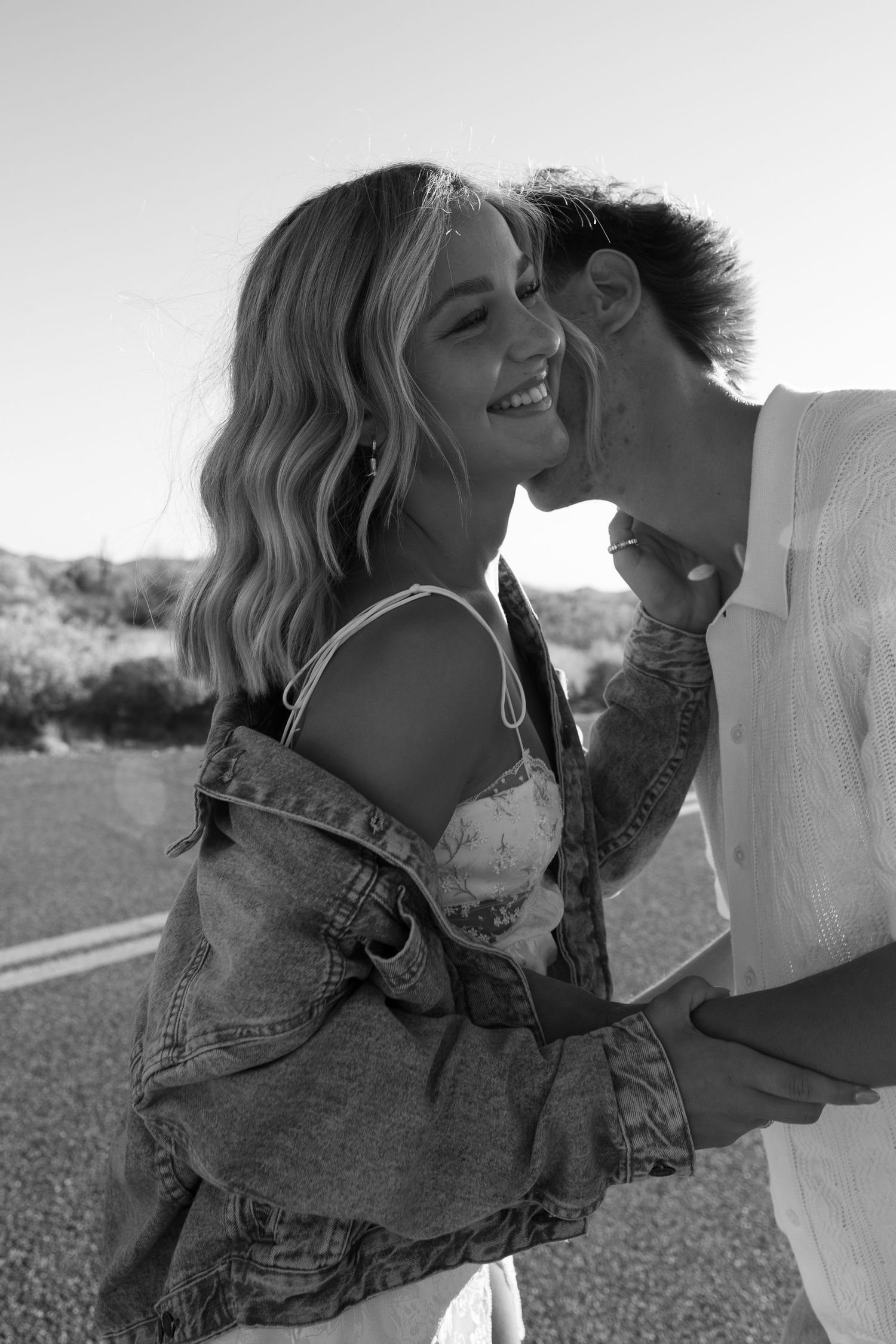 Black and white romantic photo series showing couple in denim embracing and sharing intimate moments outdoors.