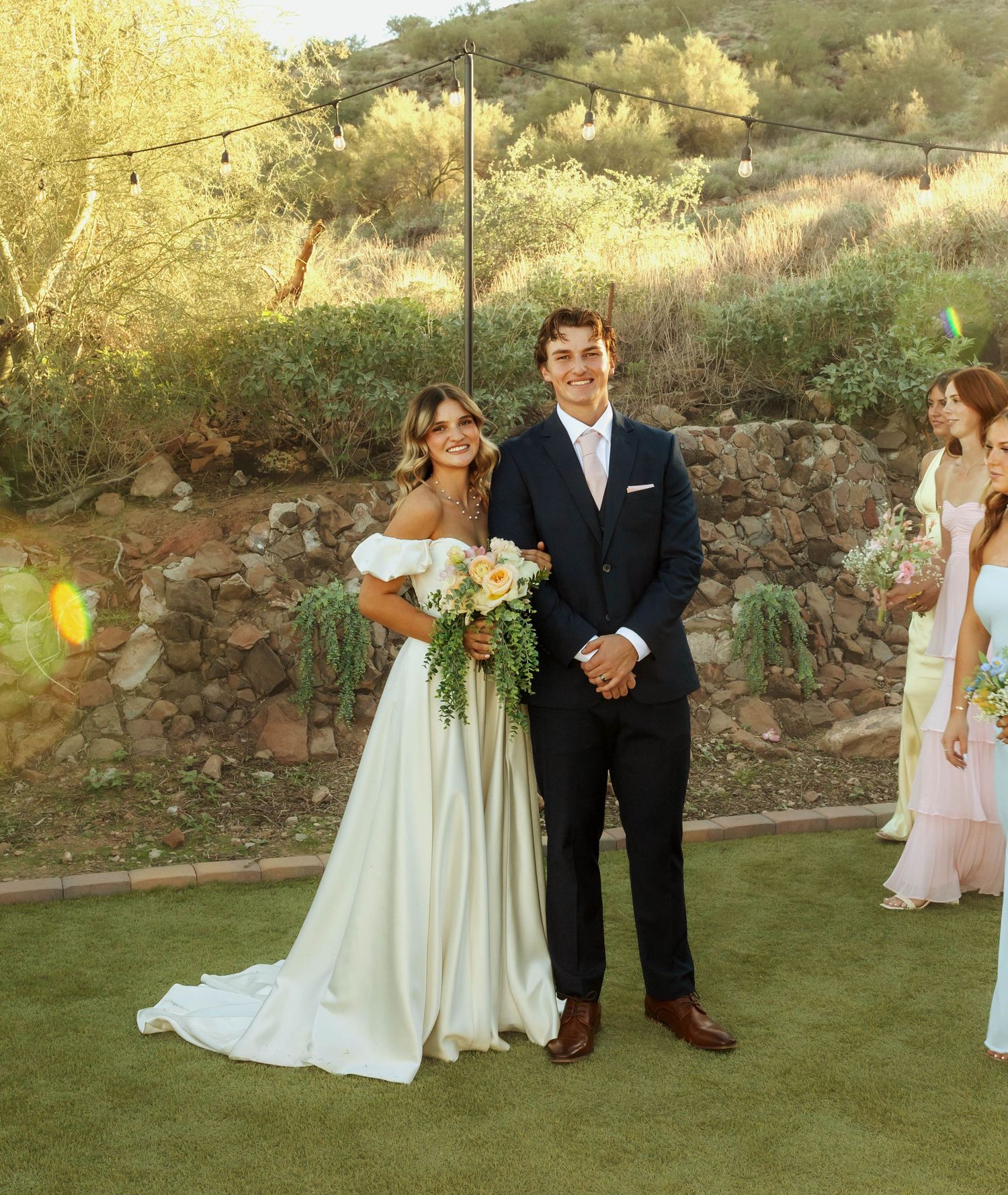 A couple celebrates their wedding day in a scenic desert garden setting.