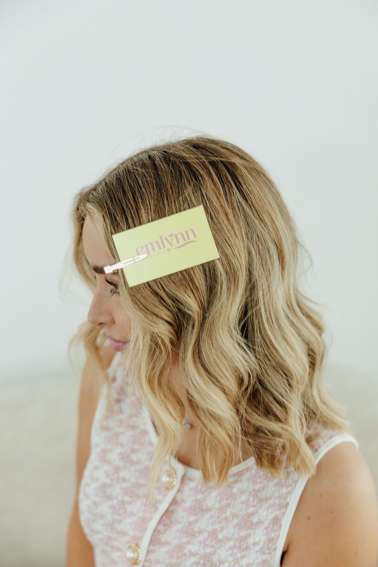 Side view of blonde wavy bob hairstyle shown in multiple angles with soft lighting against white background.