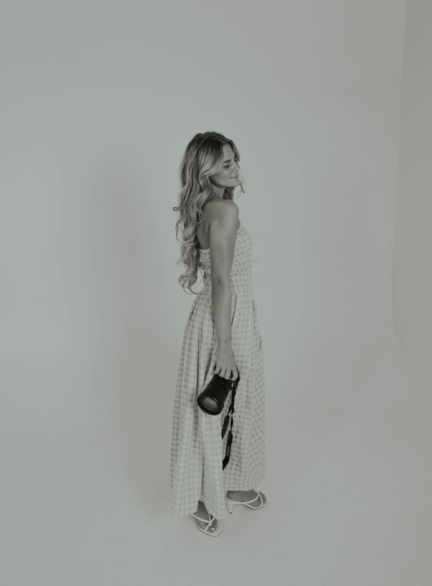 A series of black and white showing a figure in a dress walking forward in sequential motion.