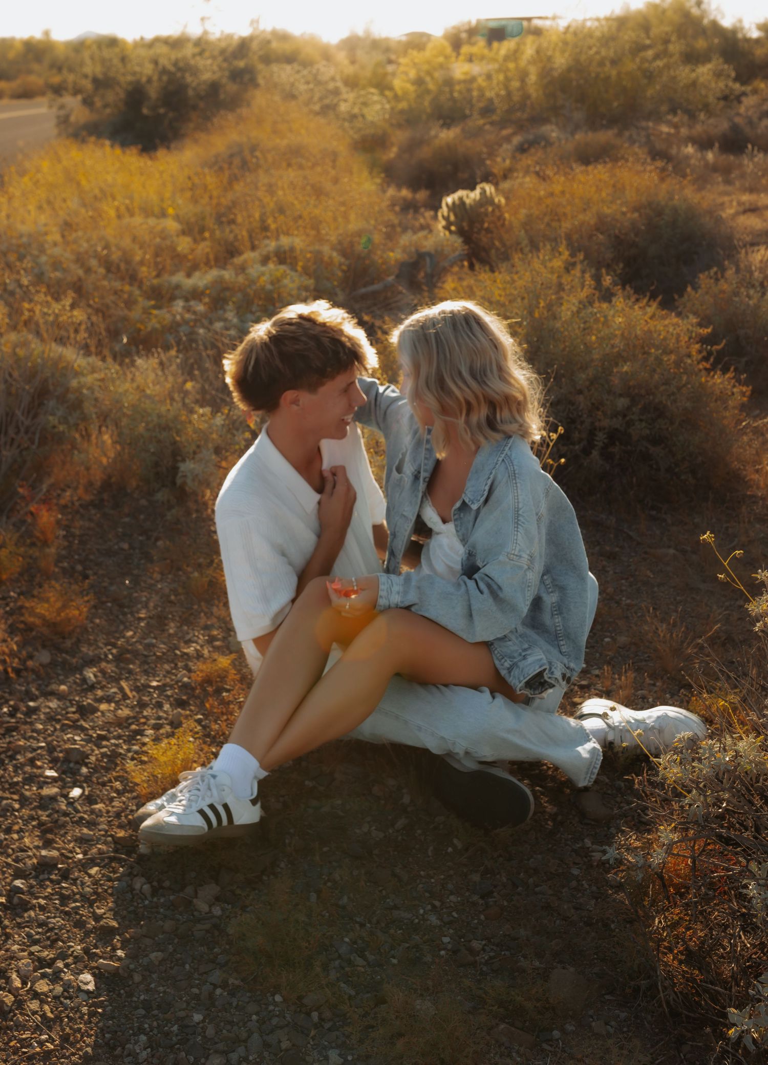 Intimate Arizona Couples Photographer captures moments at sunset on a hillside with golden desert brush in the background.