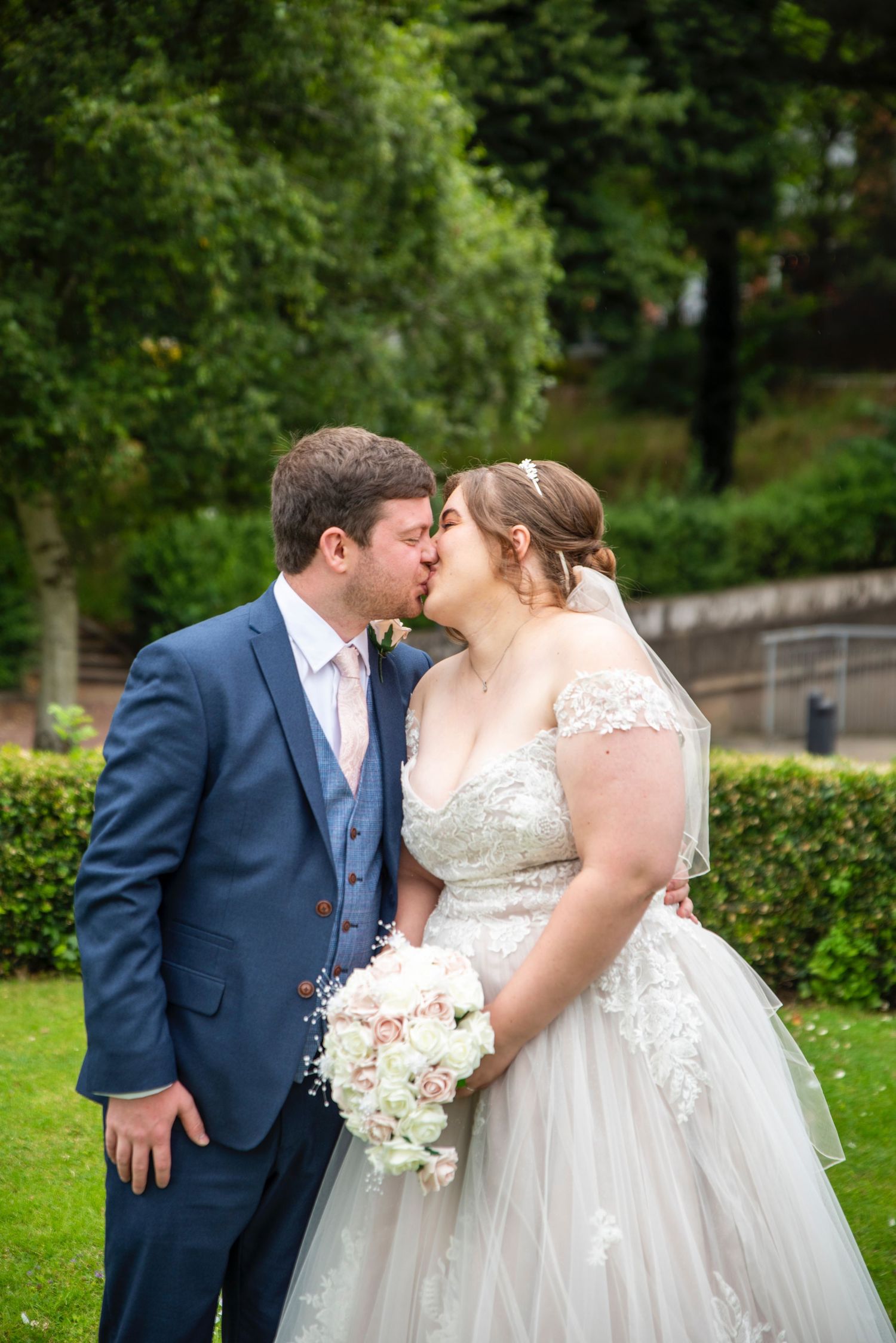 A romantic wedding moment captured in a lush garden setting.