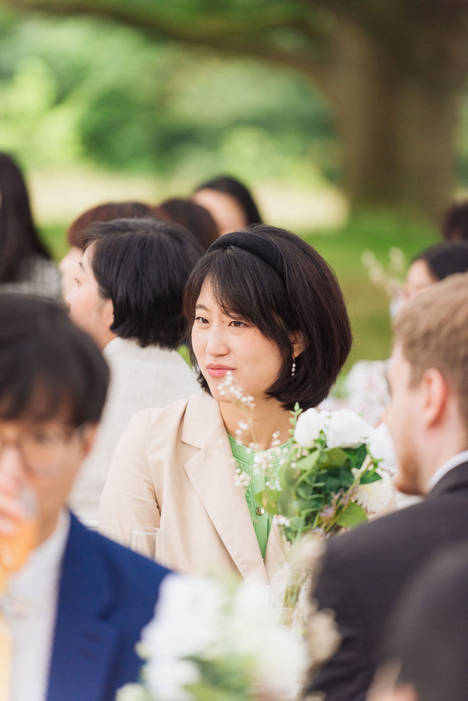 Guests enjoying conversation during an elegant outdoor garden party.