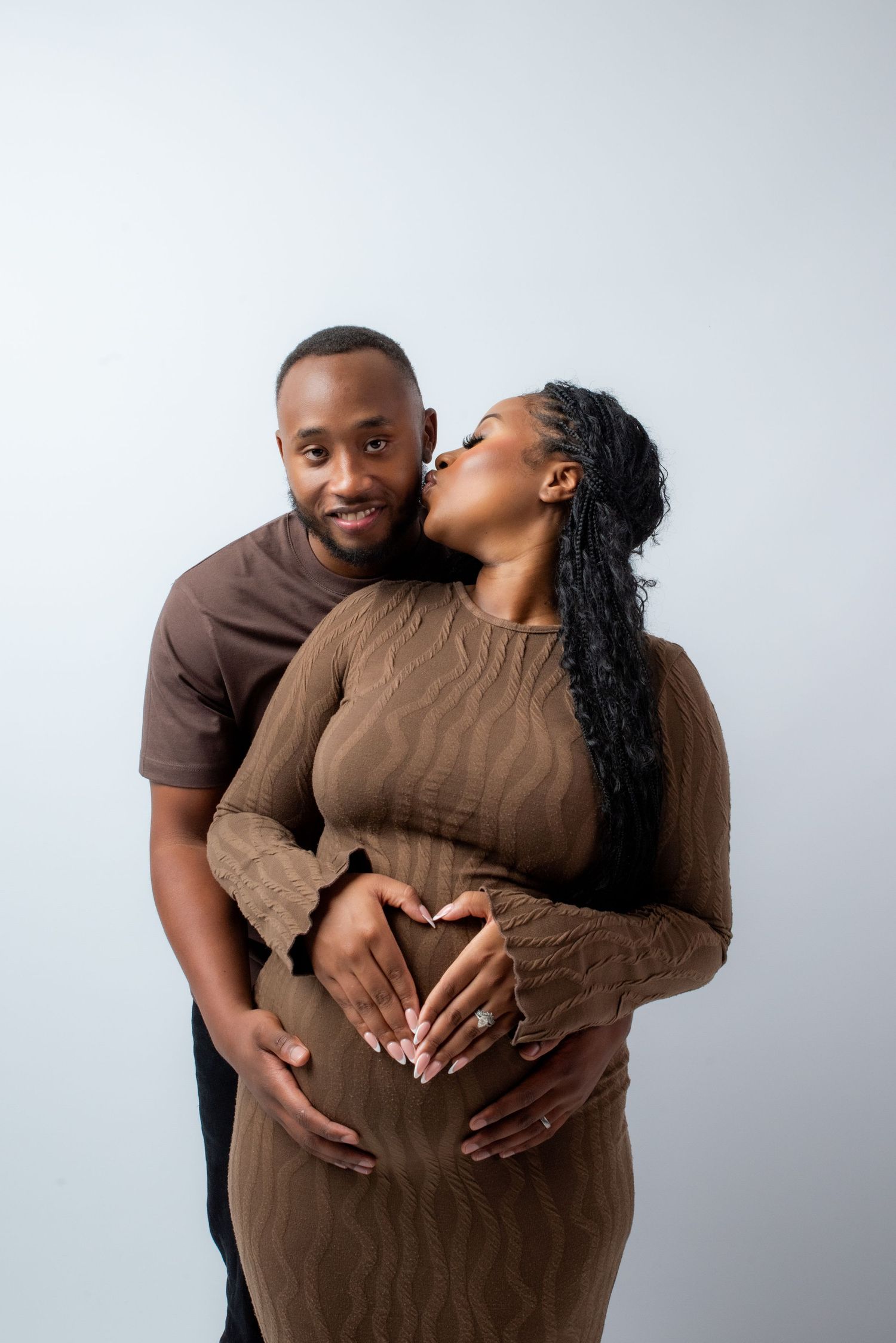 A loving couple wearing brown outfits embrace and share affectionate moments in a series of three studio photos.