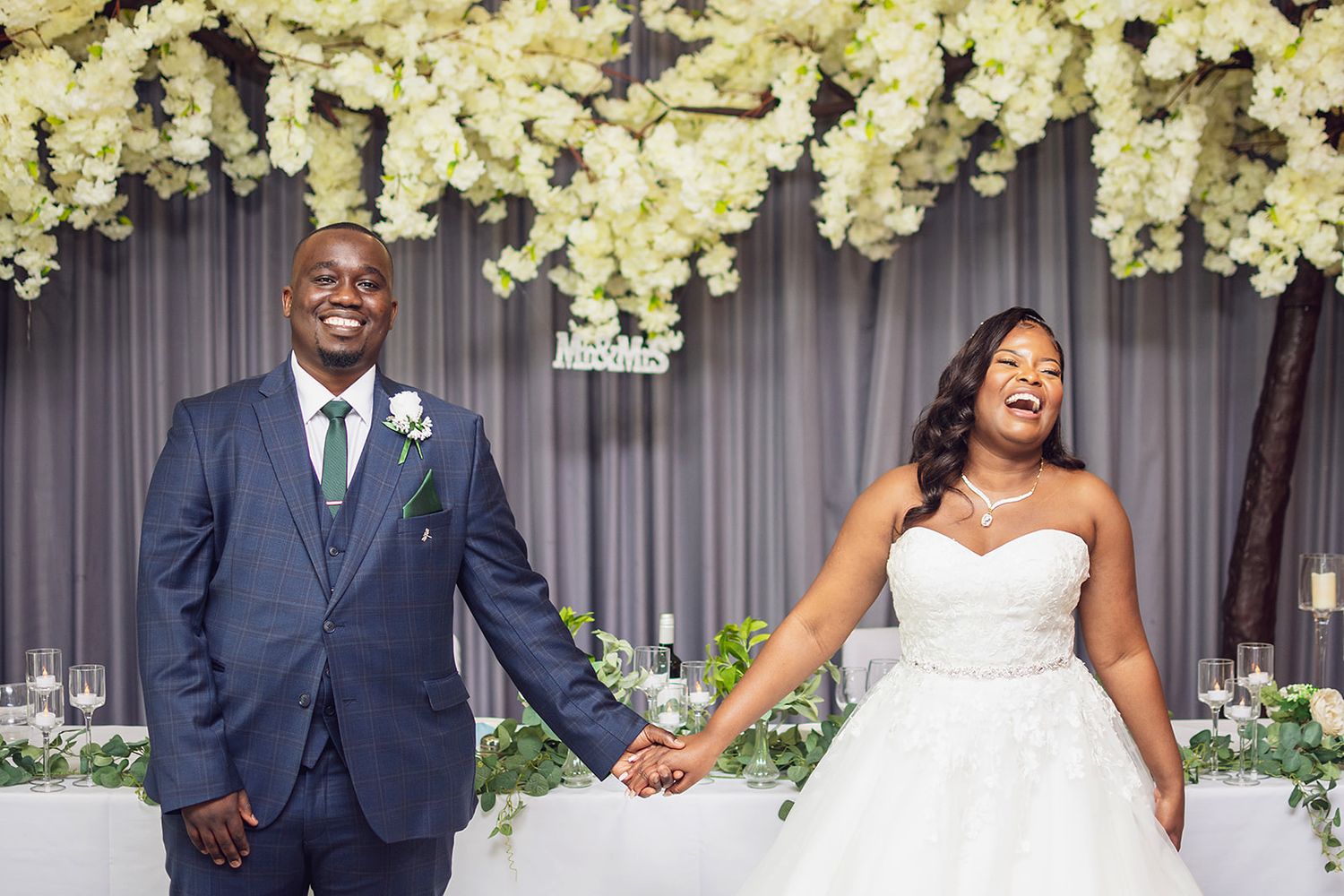 A wedding ceremony setup with elegant white floral arrangements and decor.