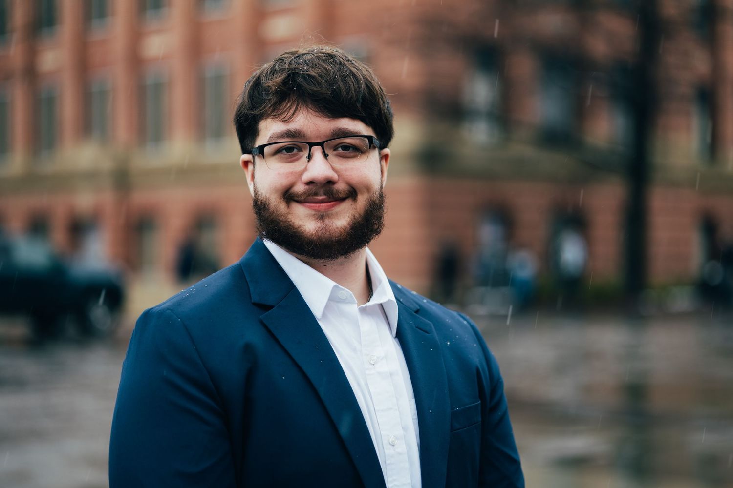 Professional headshots showing graduate in formal attire and graduation cap.