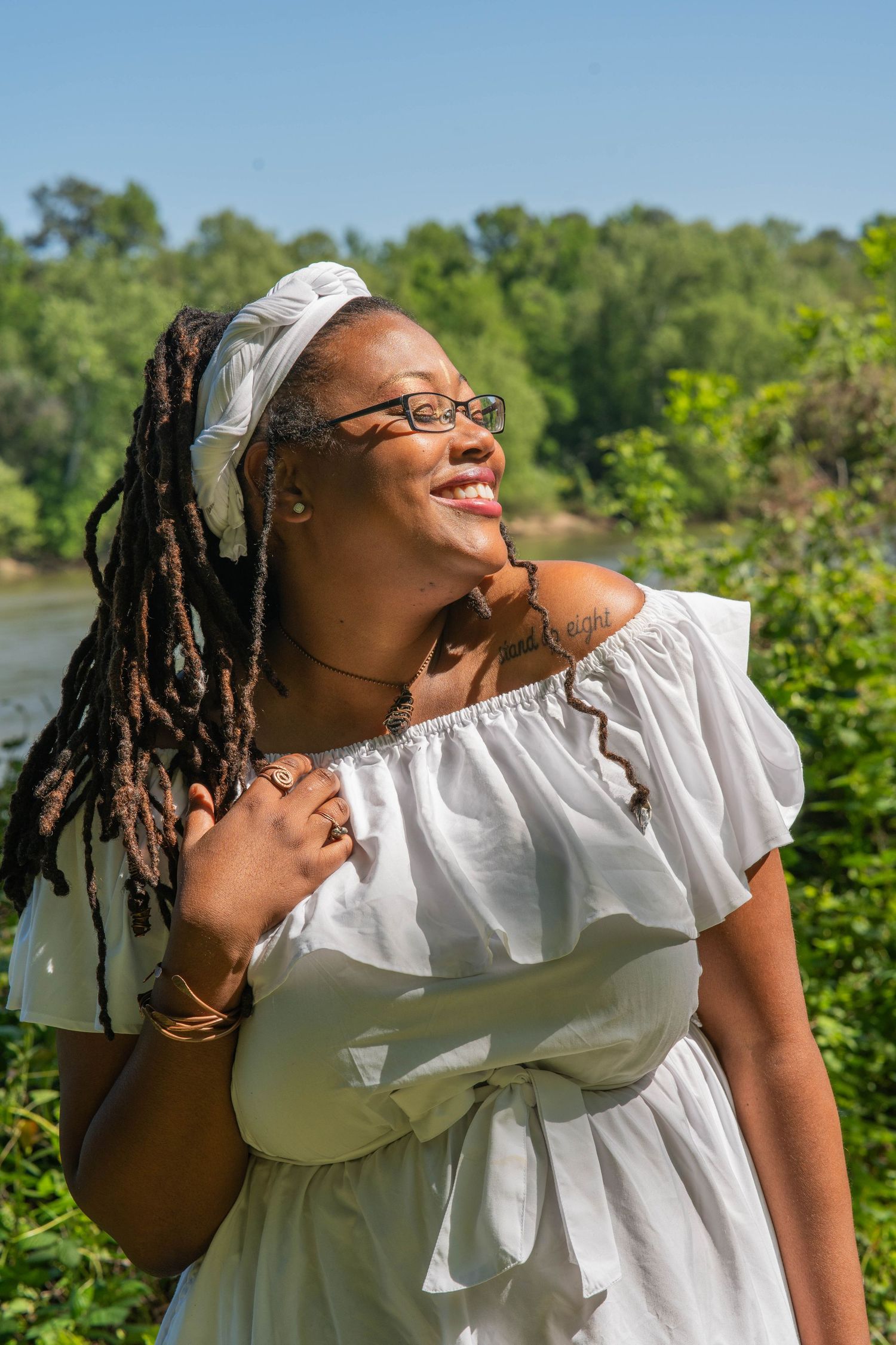 Joyful outdoor portraits in white clothing against lush green natural background.