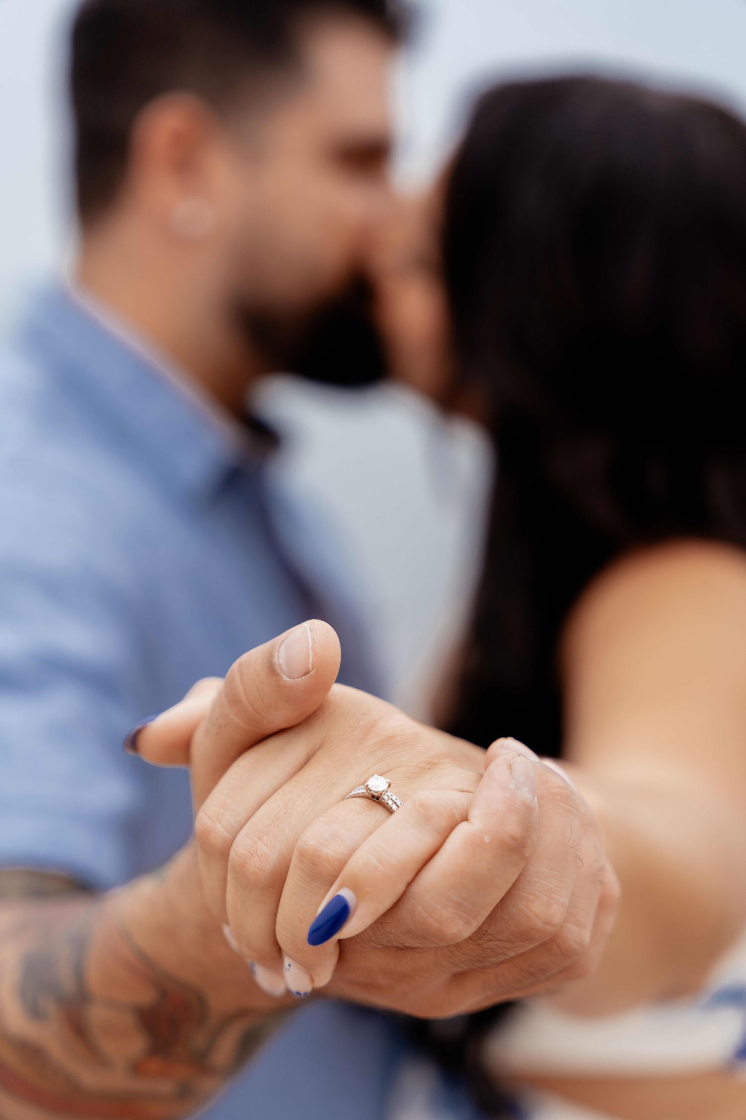 Close-up series showing an engagement ring on a hand with a blurred background.