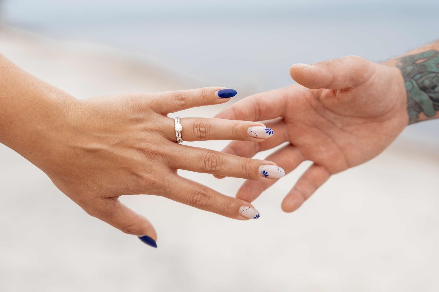 Close-up view of hands exchanging wedding rings during a romantic ceremony.