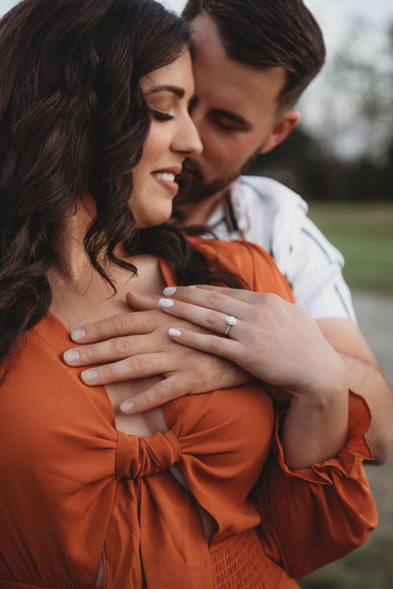 A romantic engagement photo sequence showing a couple in an orange sweater and white shirt embracing outdoors.