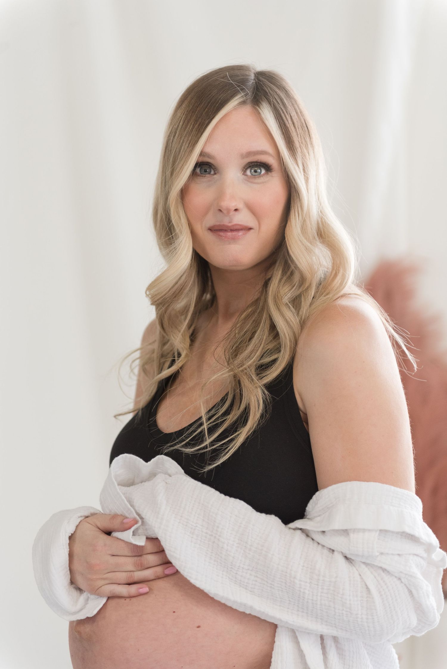 A series of intimate boudoir photos showing a person in a white off-shoulder sweater and black top against a light background.