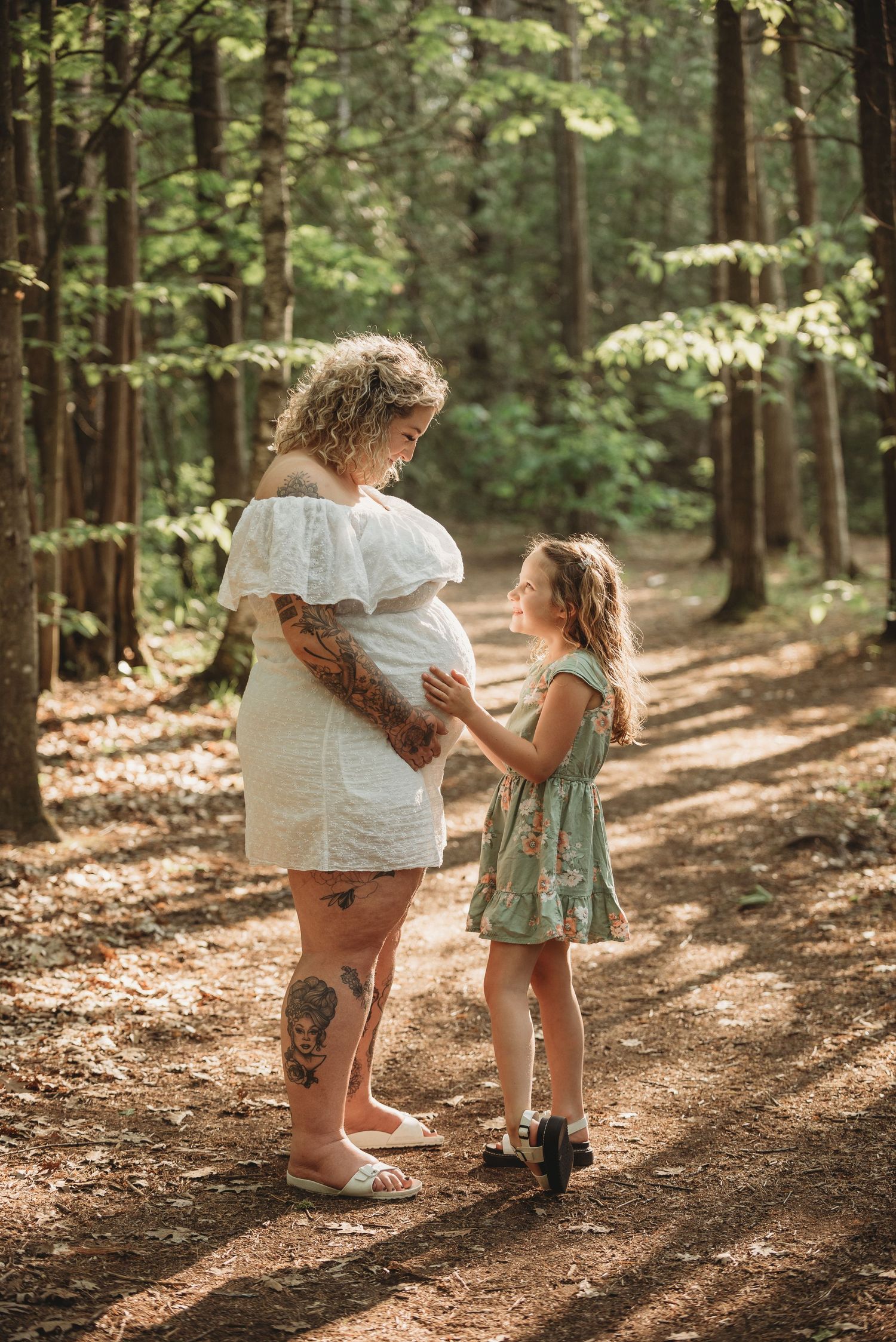Three connected photos show two children playing together on a sunlit forest path surrounded by tall trees.
