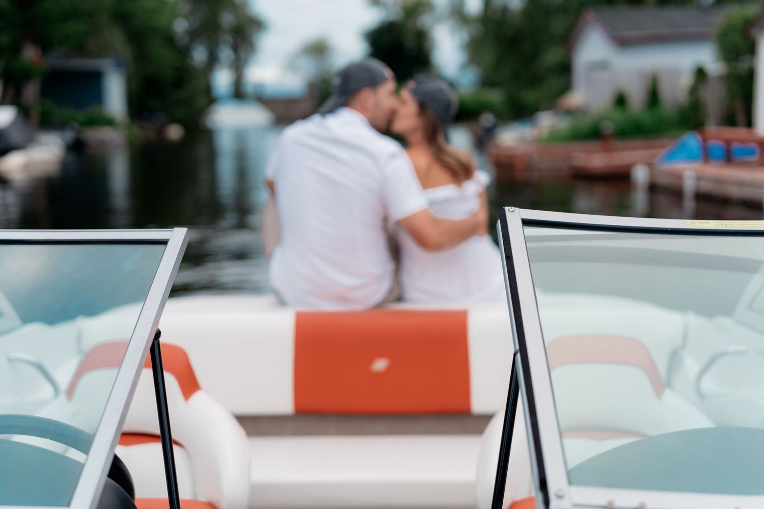 Couple sharing a romantic moment at an outdoor restaurant patio with white and turquoise decor.