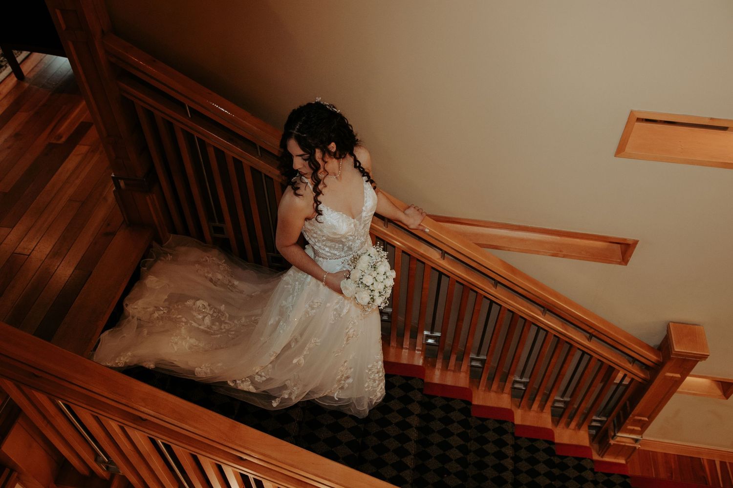 Bride descending the staircase at Raheen Woods Hotel in Athenry, Galway, captured during an elegant wedding ceremony