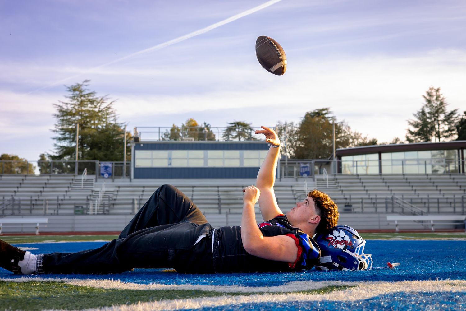 Analy high school senior throwing football in portraits by smc shots of Sebastopol