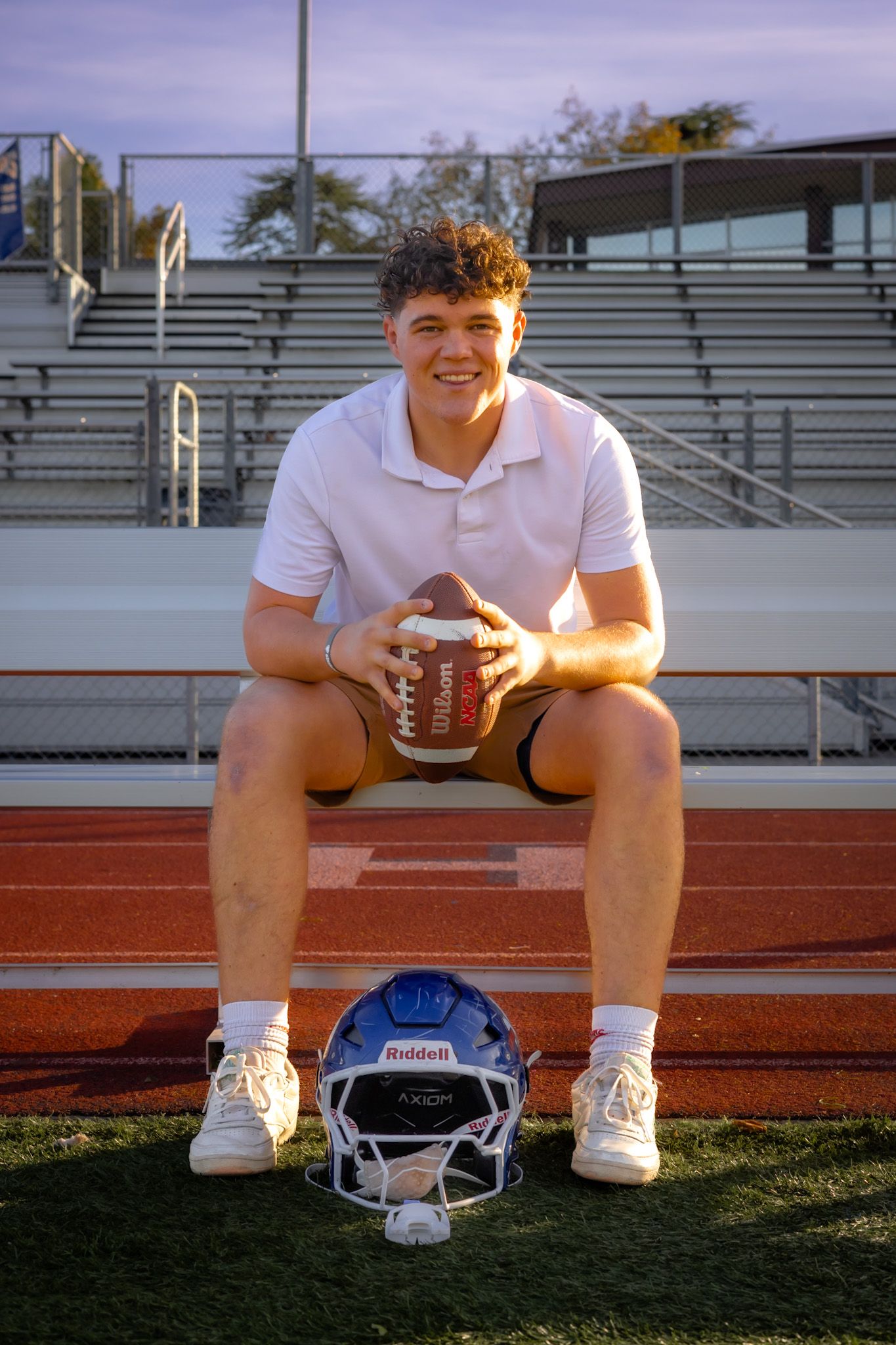 Analy high school senior sitting with football in portrait by smc shots of Sonoma county