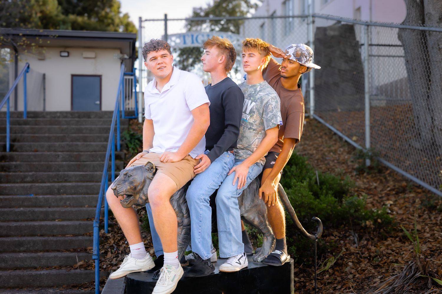 Analy high school seniors sitting on the tiger in portrait by smc shots of Sonoma county