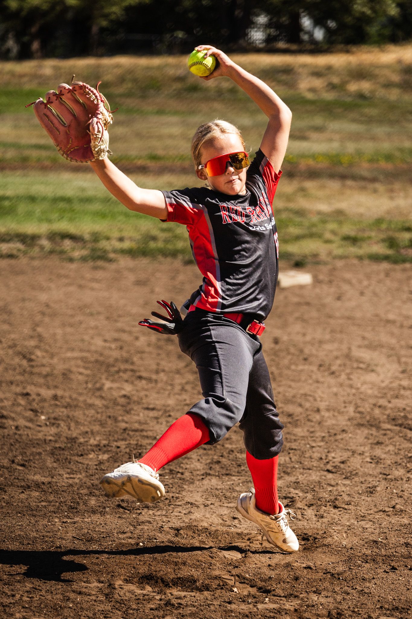 Softball girl jumping in action sports photography Sonoma county by SMC shots