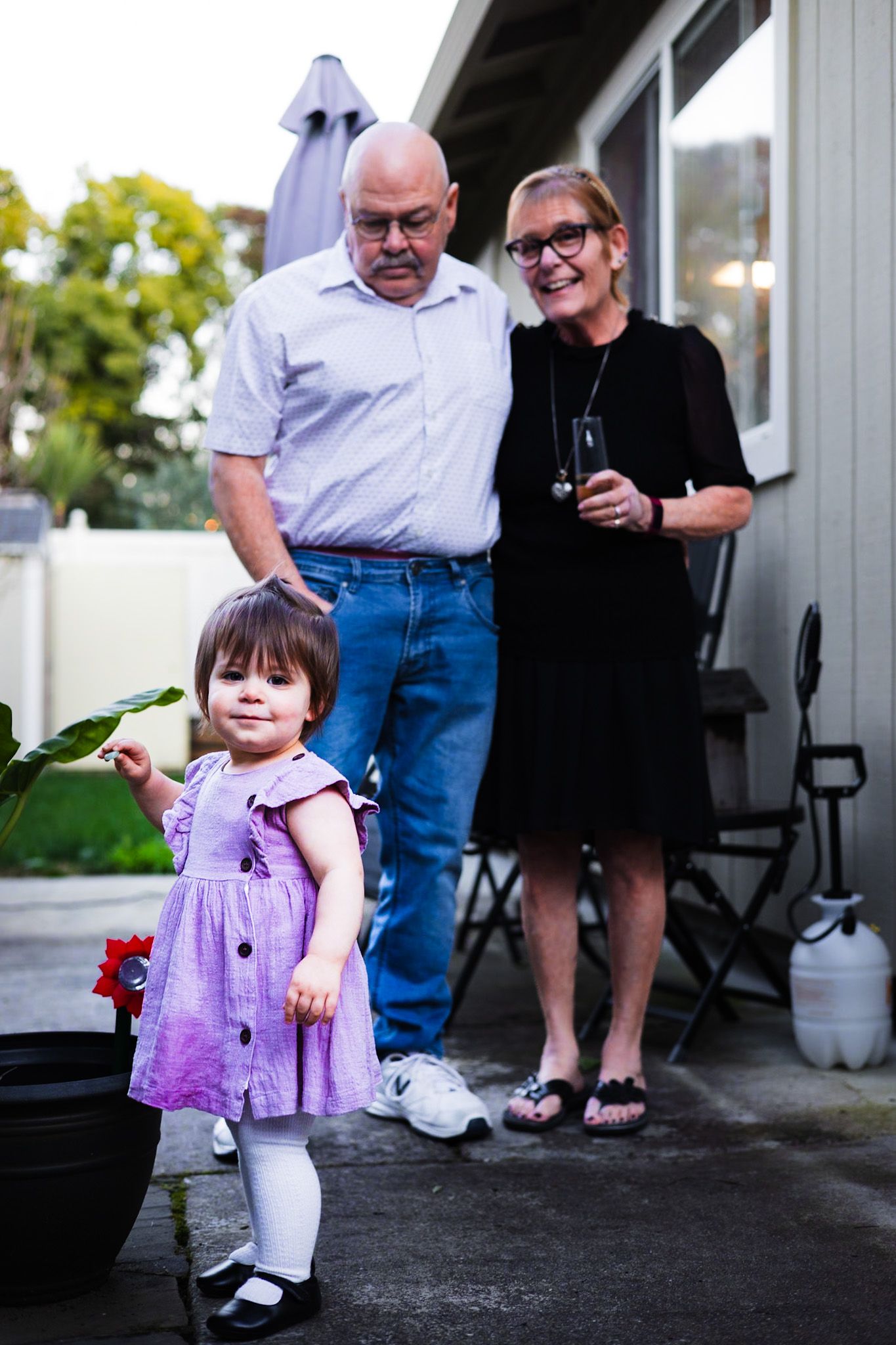 Proud grandparents tickled by their sweet granddaughter dancing outside in photo by Sonoma county photographer smc shots