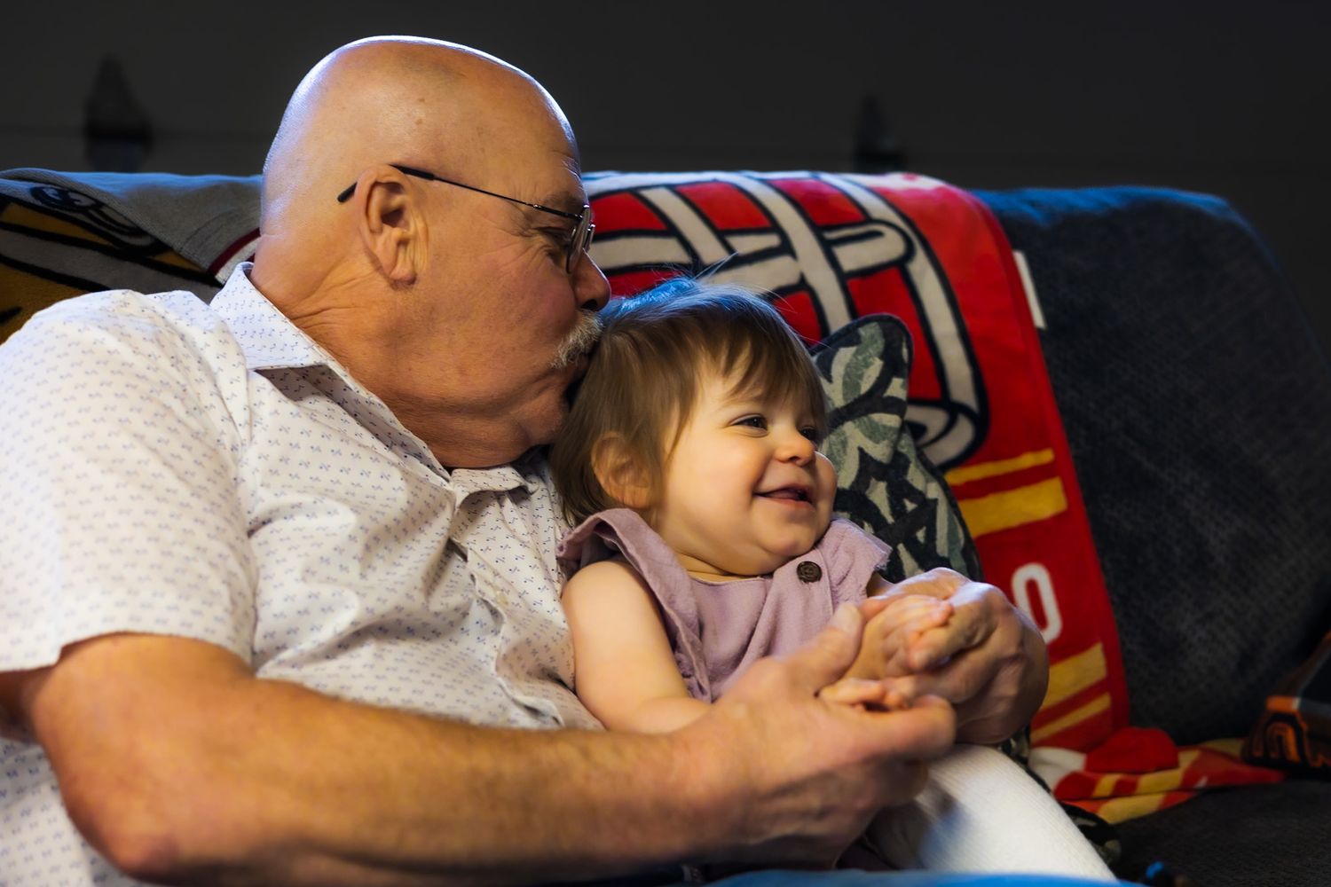 Grandpa Bob kissing his sweet girl on the couch by Sonoma county photographer smc shots