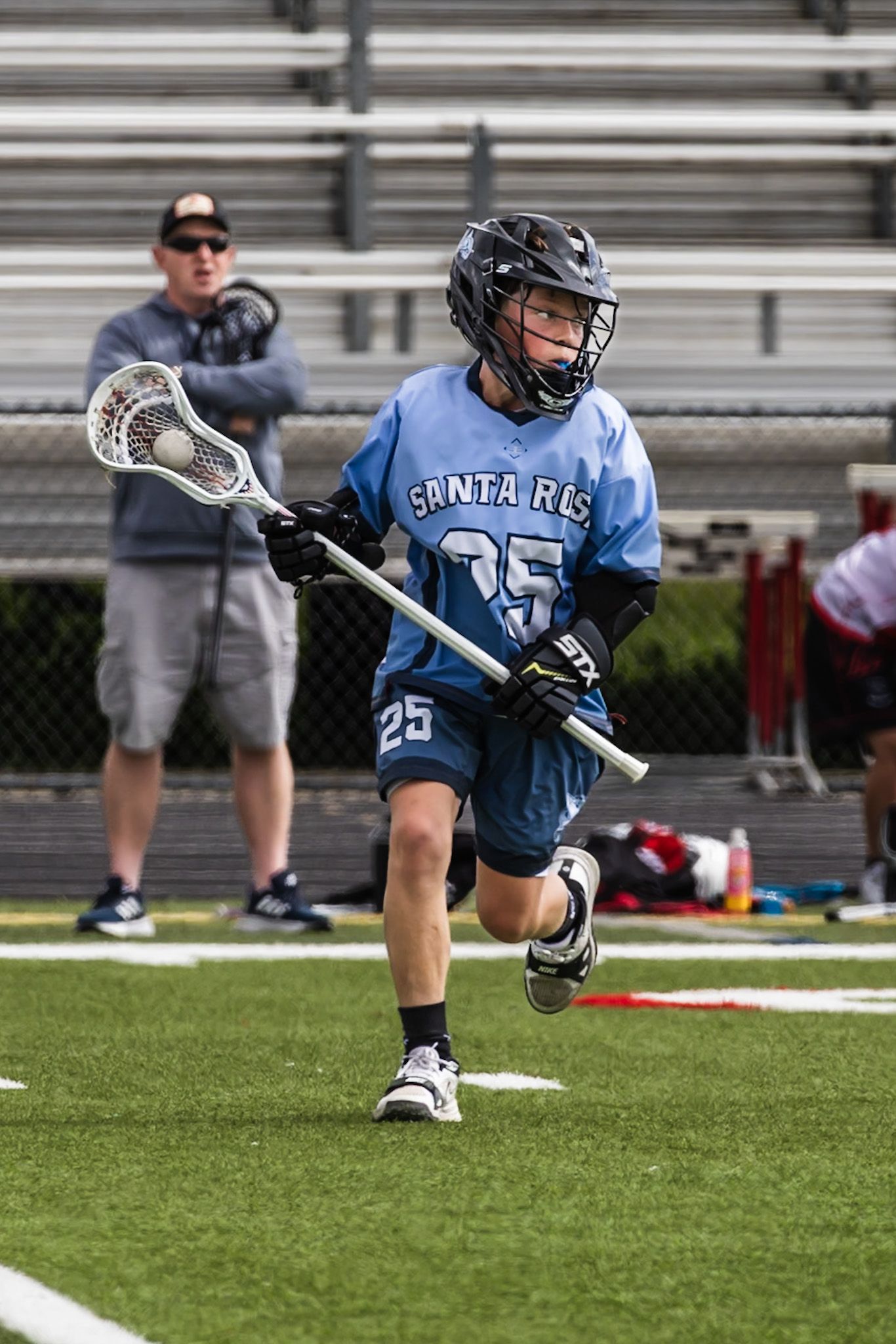 Lacrosse player running to make the play on the green by Sonoma county photographer smc shots